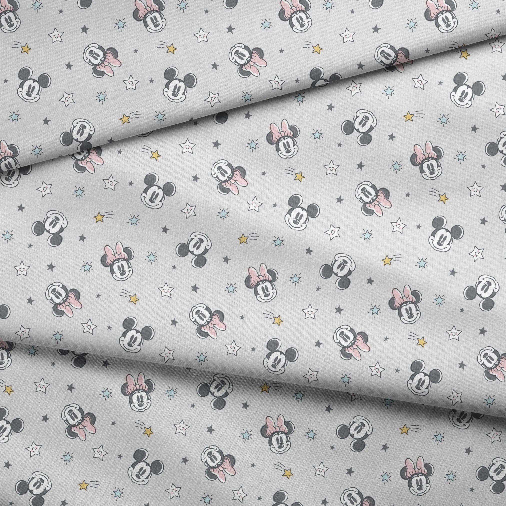 Mickey and Minnie Mouse pattern with stars on light gray background fabric fold mockup