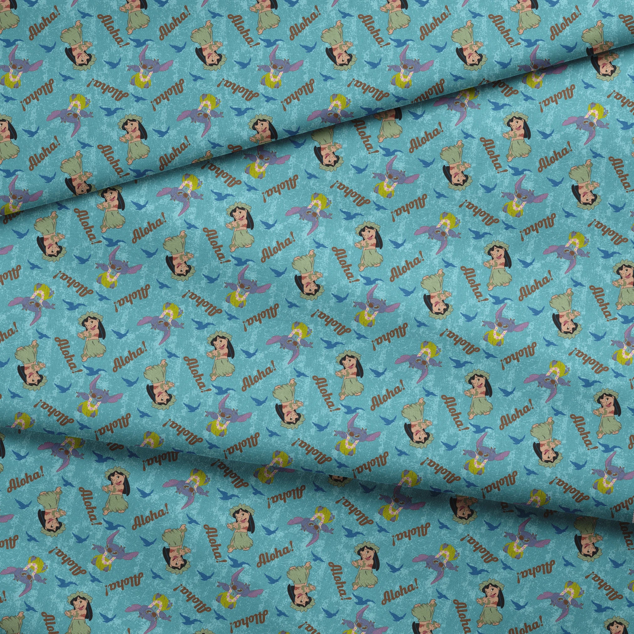 Lilo and Stitch pattern on turquoise background with "Aloha!" text and blue silhouettes fabric fold mockup
