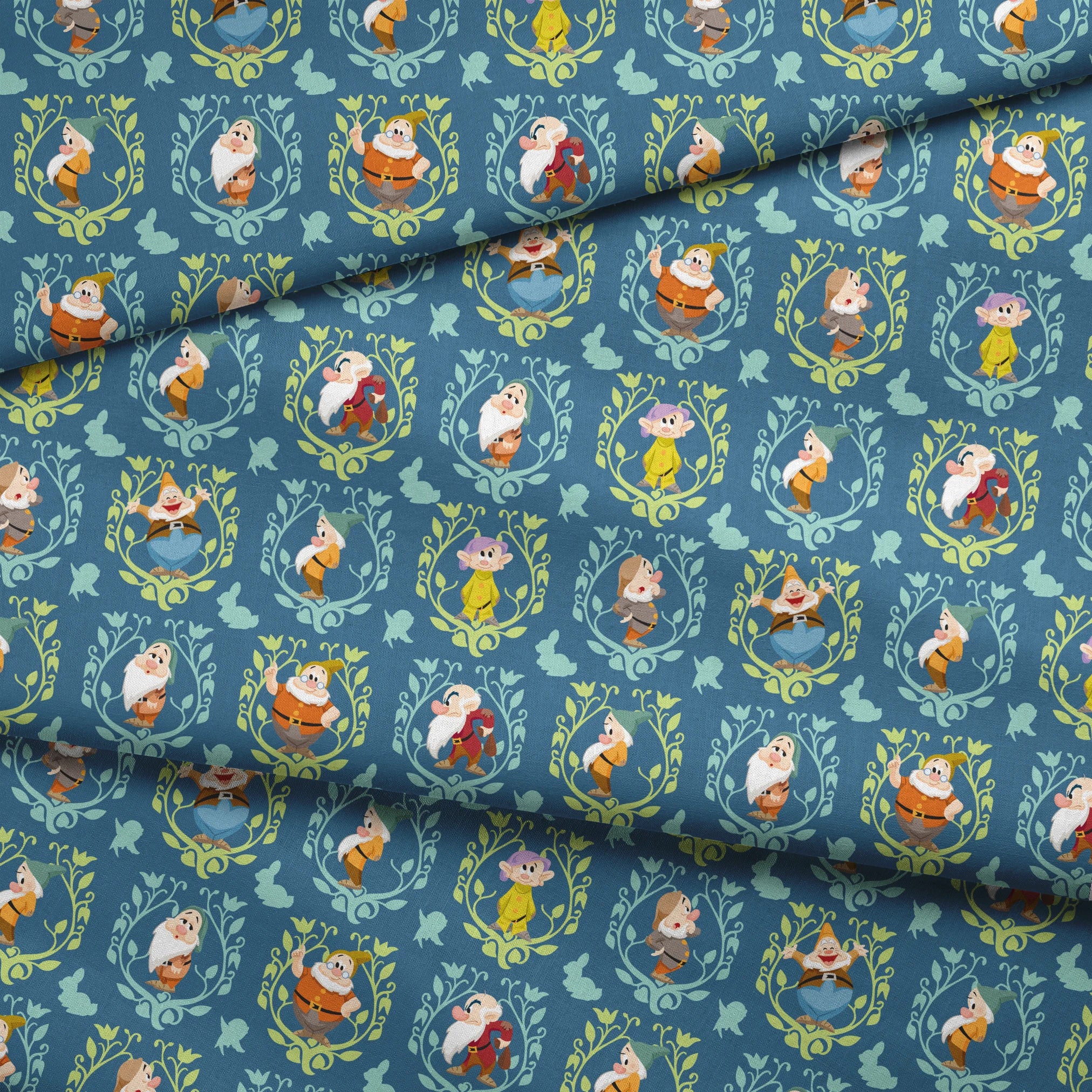 Pattern of cartoon birds in decorative oval frames on blue background with leaf motifs fabric fold mockup