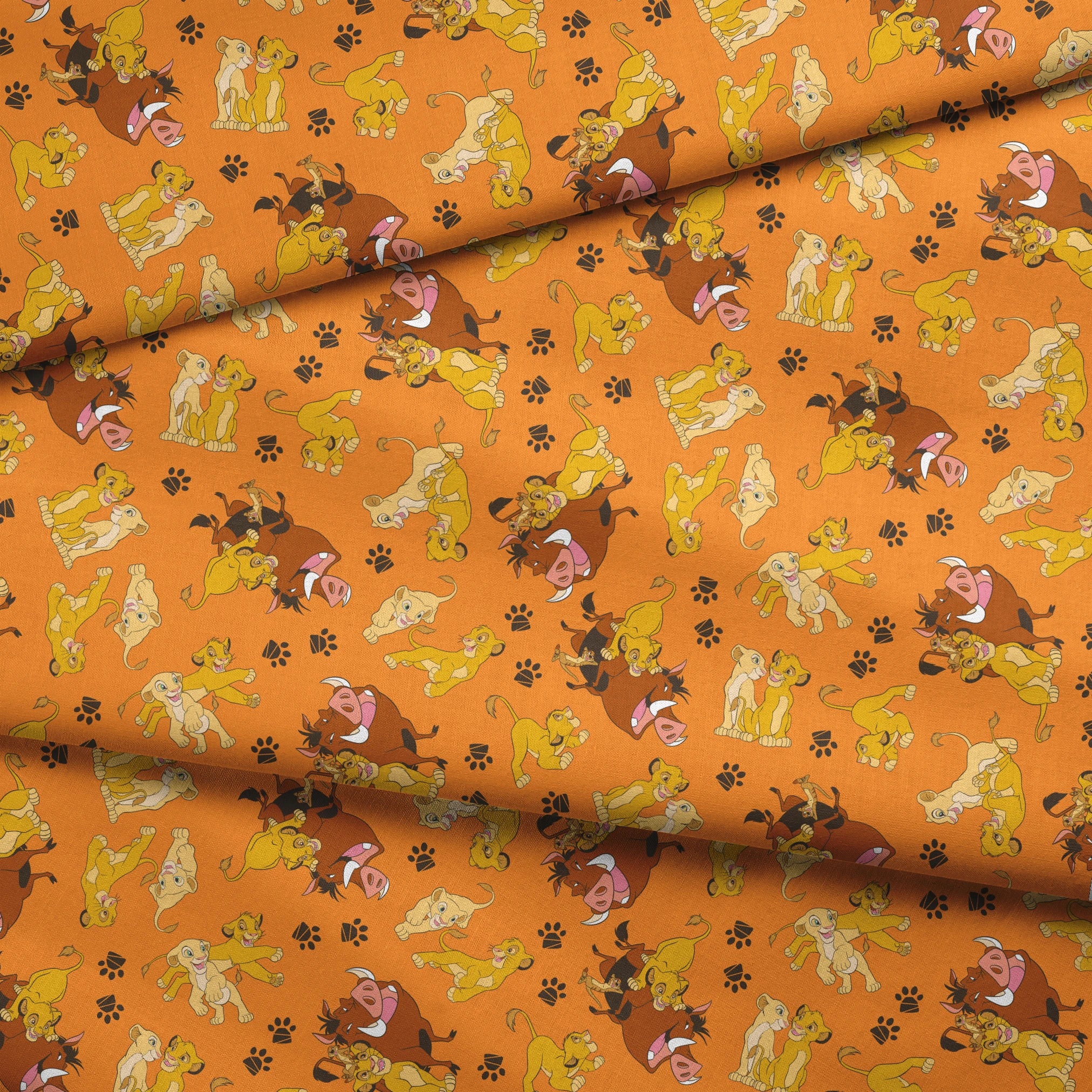 Playful pattern of cartoon cubs in yellow and brown poses on bright orange background with pawprints fabric fold mockup