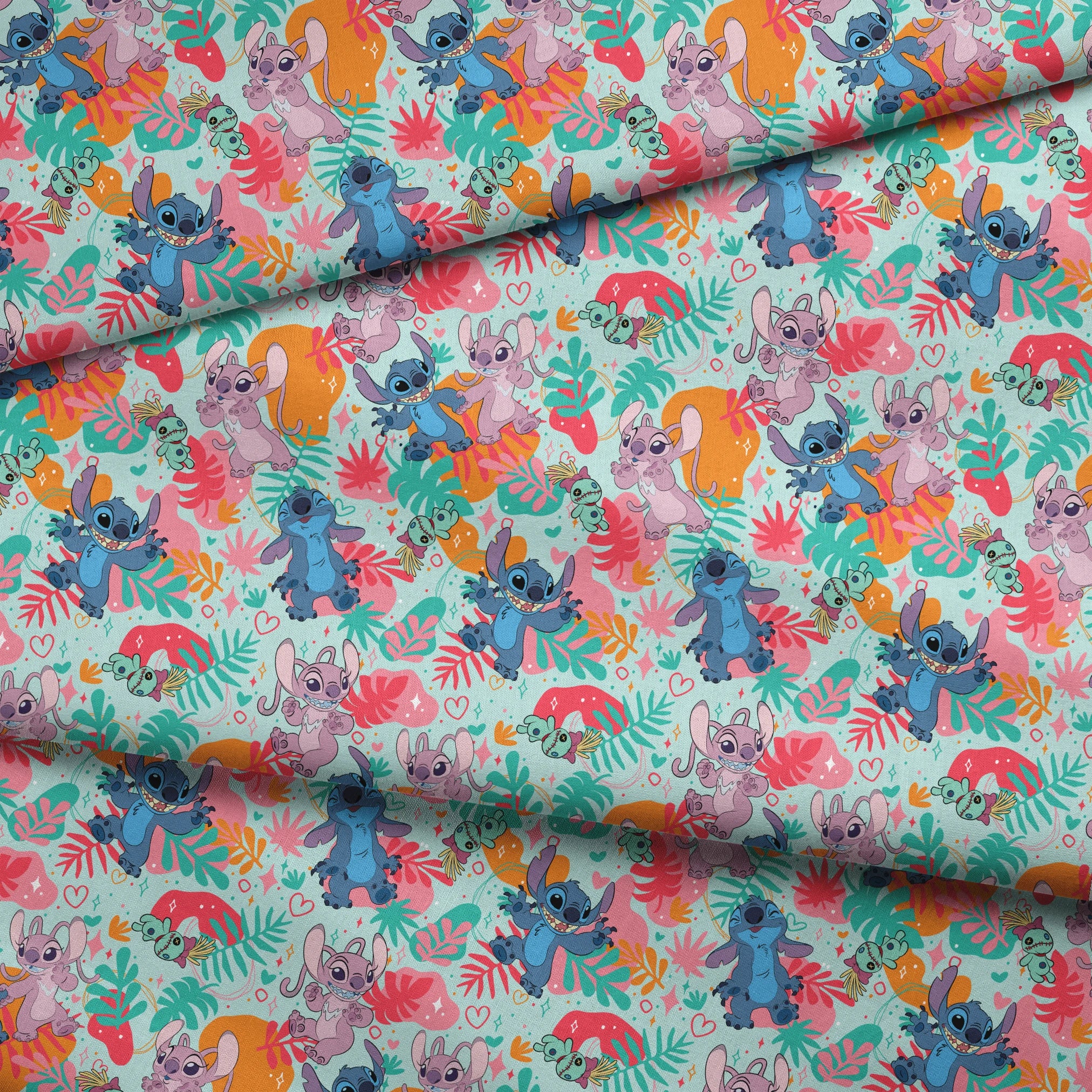 Colorful Stitch pattern with characters from Lilo & Stitch amid tropical leaves on turquoise background fabric fold mockup