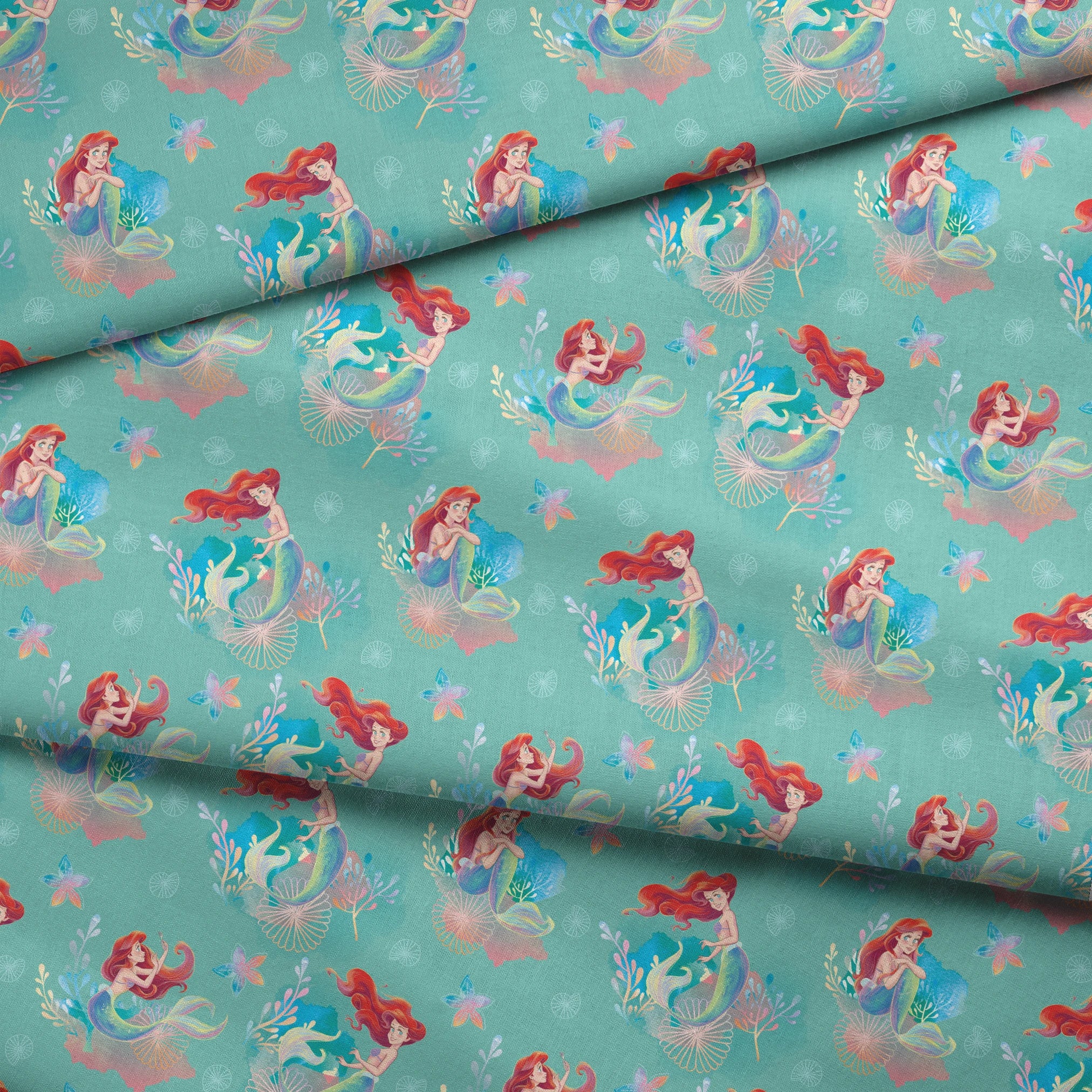 Whimsical teal pattern featuring mermaids with red hair, seashells, starfish, and coral in pastel colors fabric fold mockup