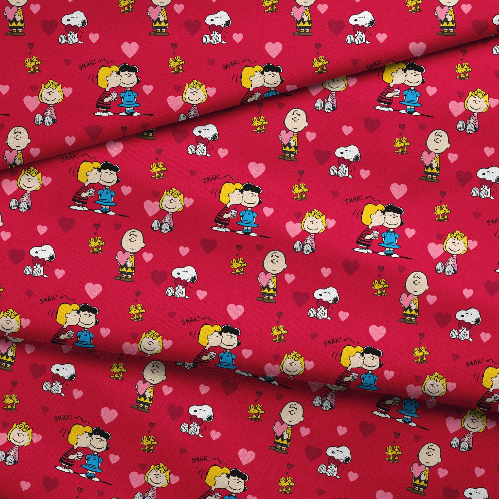 Peanuts characters on red background with hearts; Snoopy, Woodstock, and others in Valentine's theme fabric fold mockup