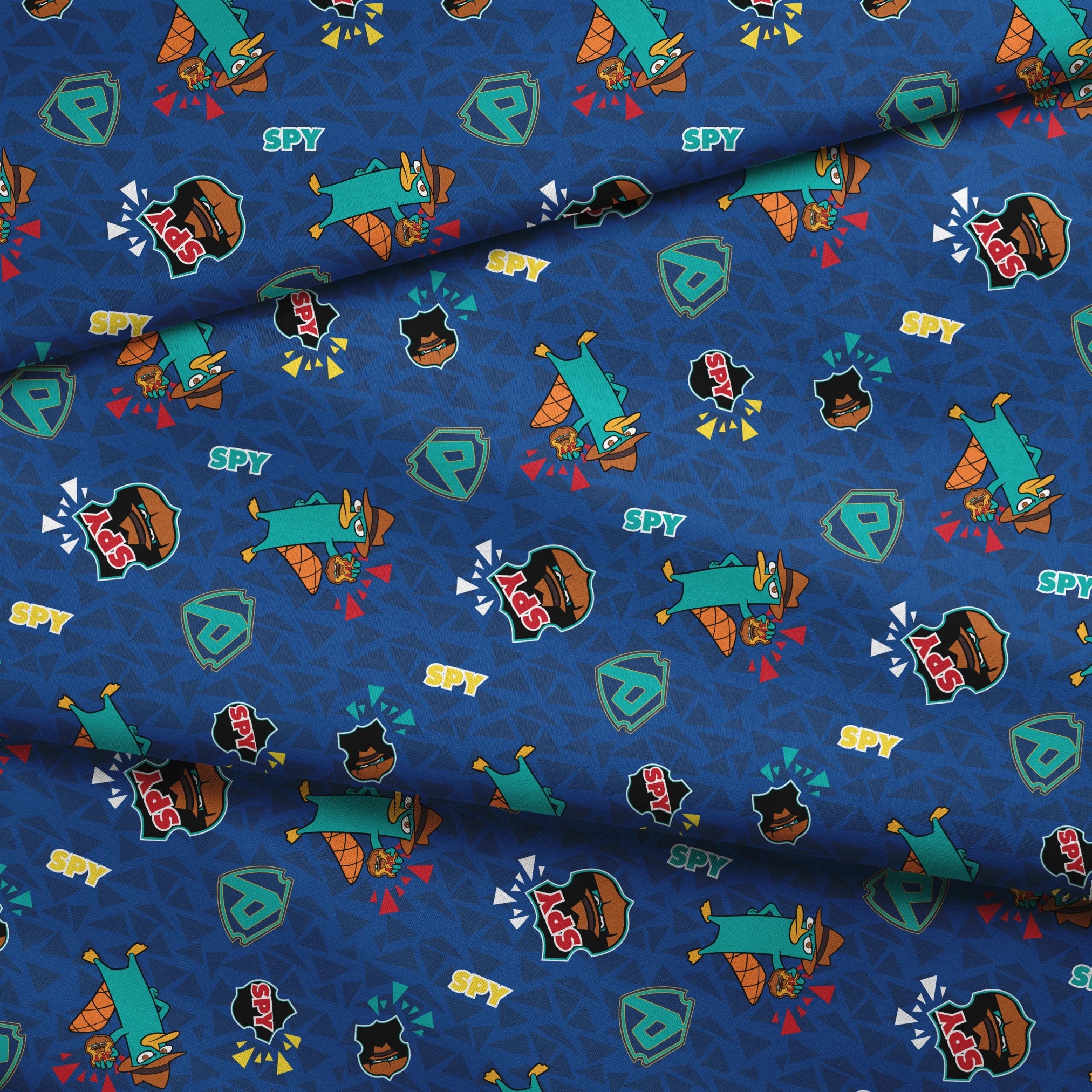 Colorful Perry the Platypus pattern with "SPY" text on blue geometric background fabric fold mockup