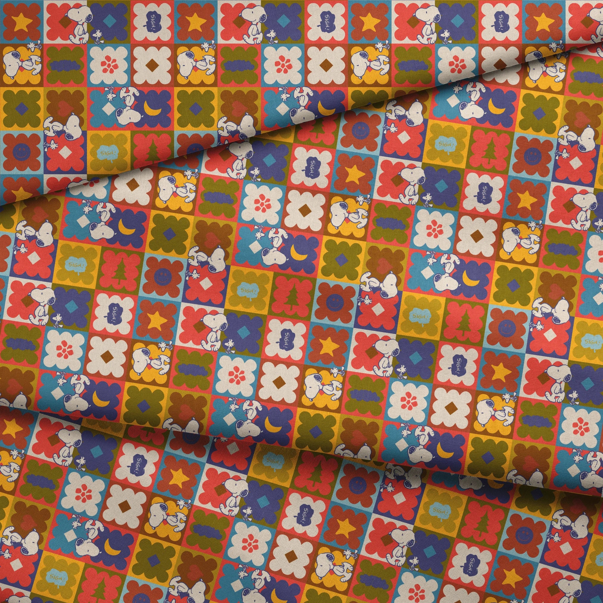 Colorful patchwork pattern featuring Snoopy characters in various squares with flowers, geometric shapes, and decorative elements fabric fold mockup