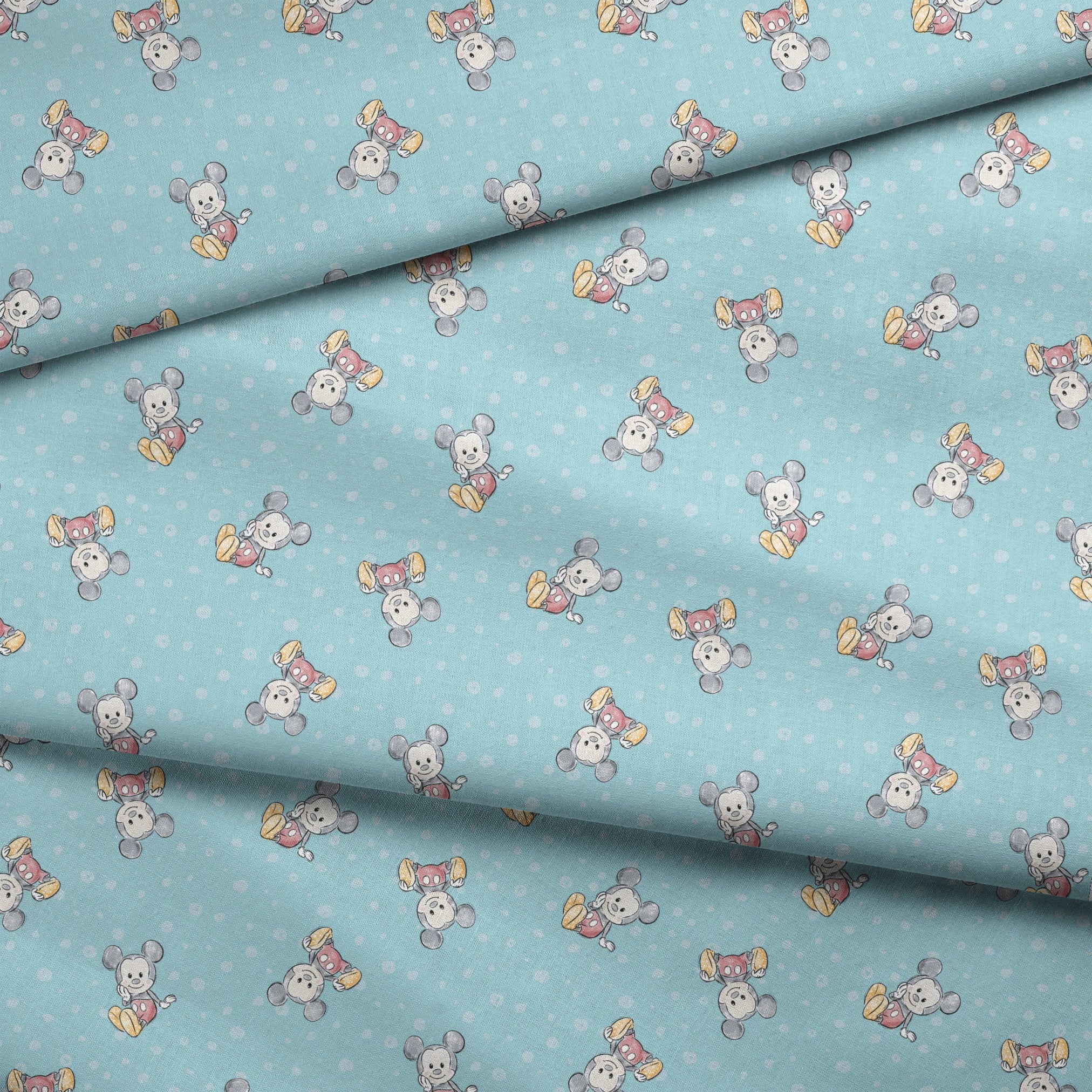 Cute cartoon mouse pattern with gray mice wearing colorful outfits on light blue polka dot background fabric fold mockup