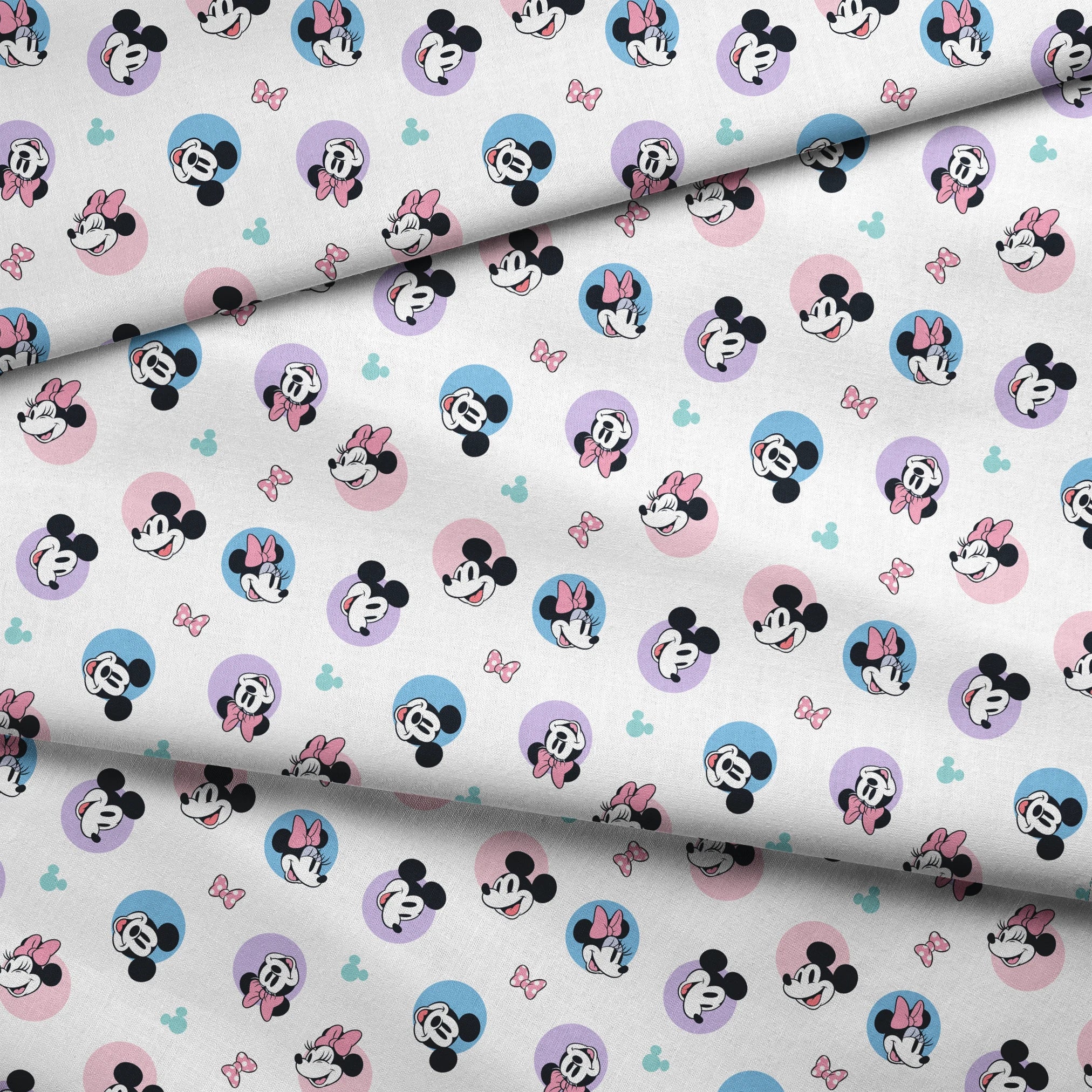 Disney Mickey and Minnie Mouse pattern with character heads on pastel circles, pink bows, and small Mickey icons fabric fold mockup