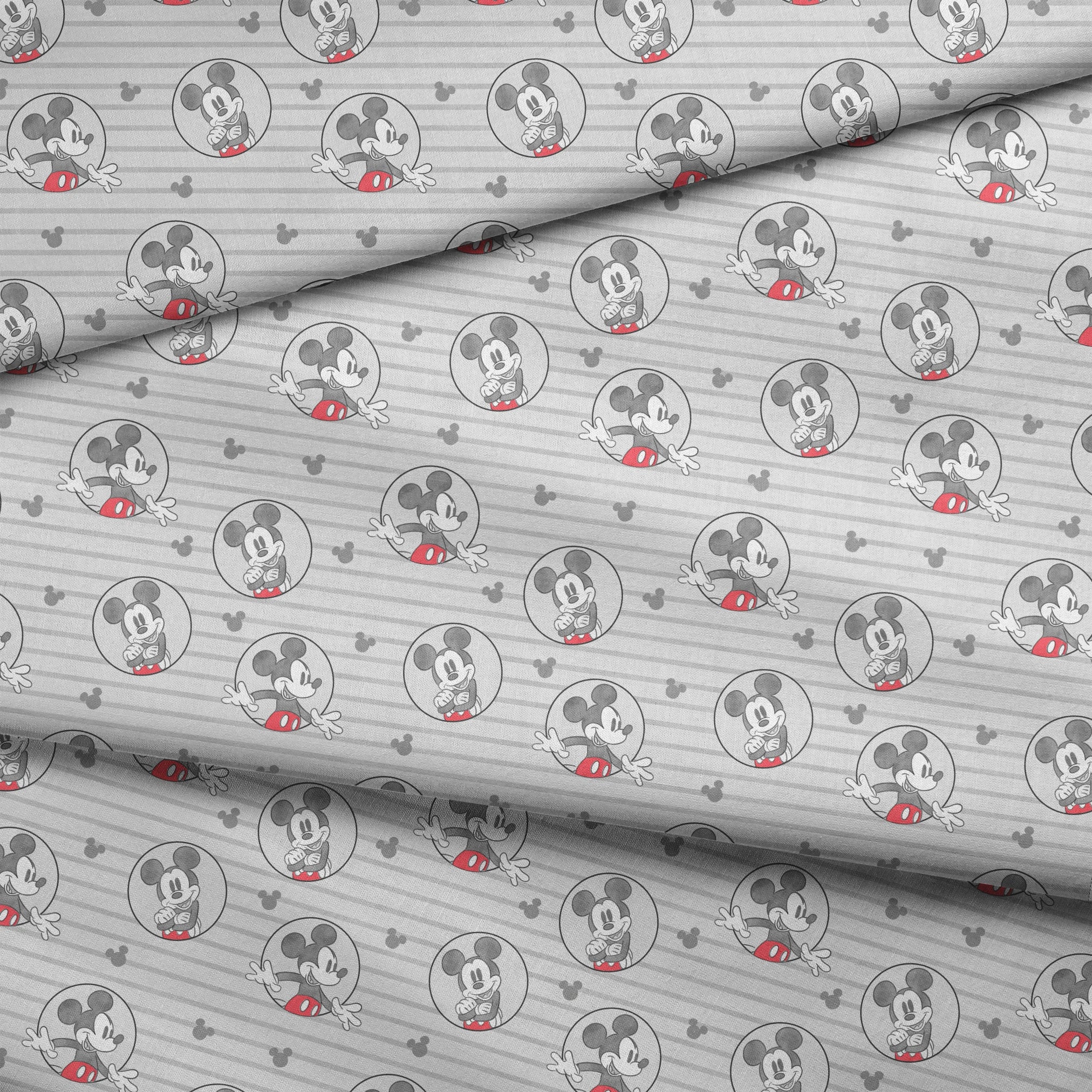 Mickey Mouse pattern on gray striped background with circular character portraits in red, black, and white fabric fold mockup