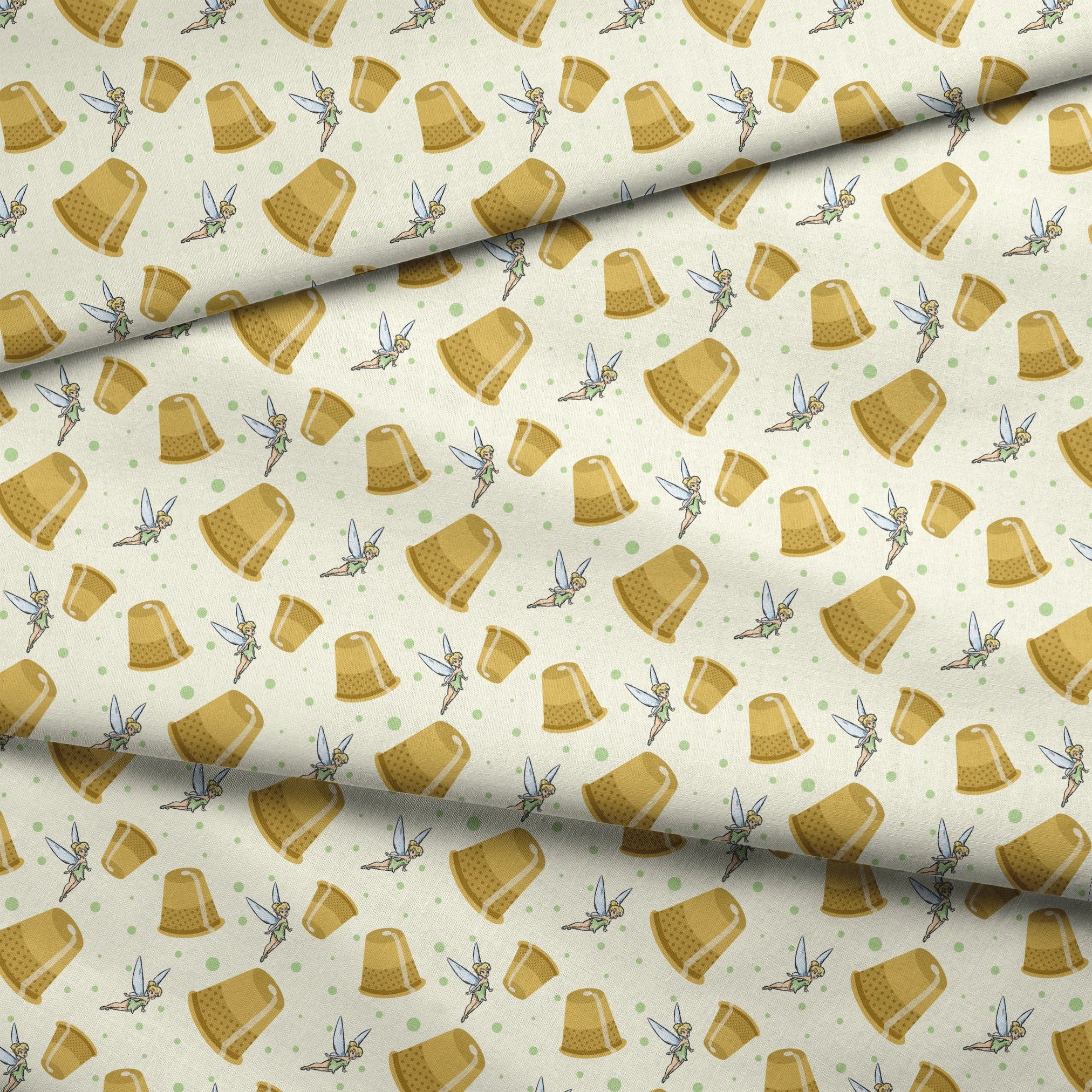 A pattern featuring Tinkerbell fairy with golden thimbles on a pale background with green dots. fabric fold mockup