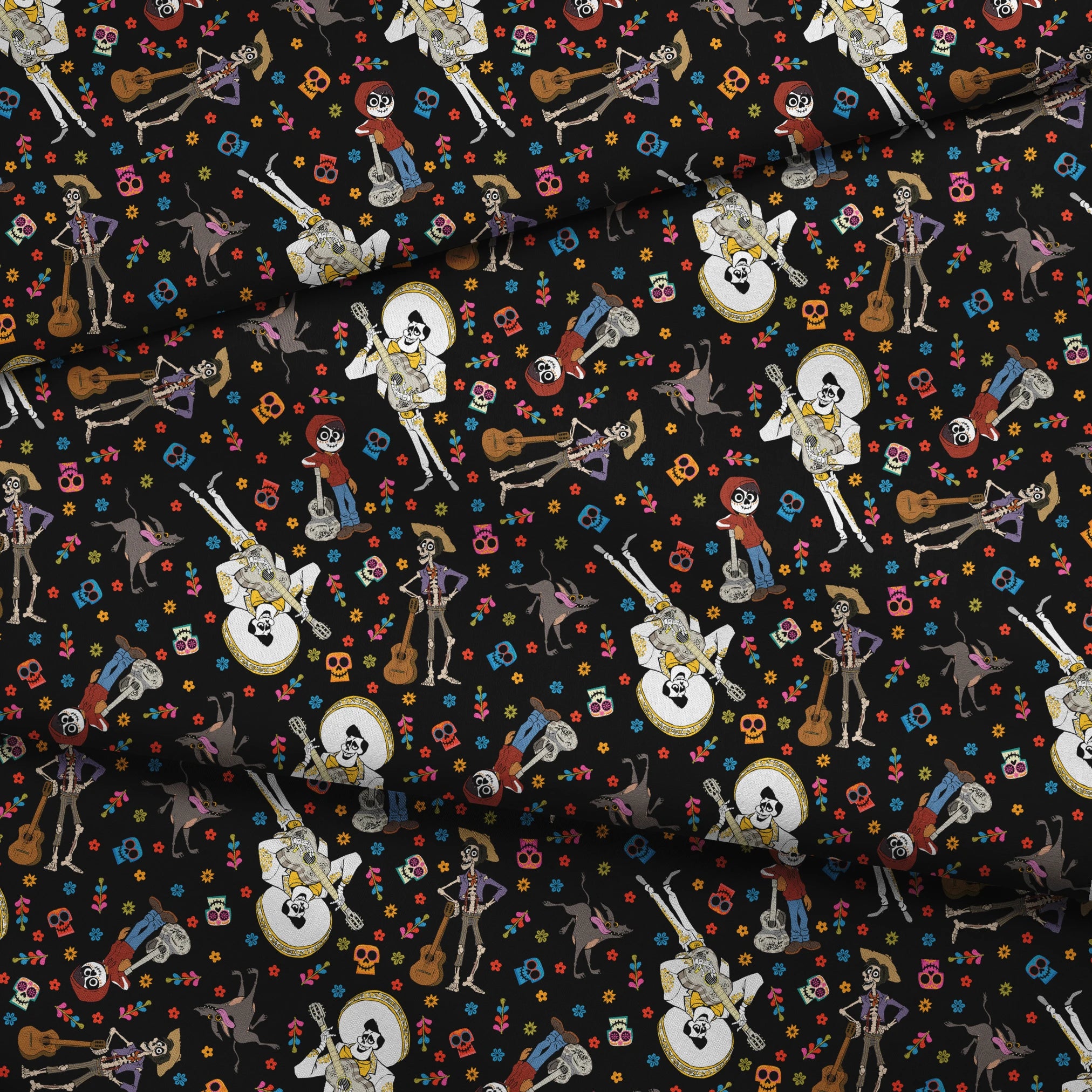 Colorful Coco Day of the Dead pattern with skeleton figures playing instruments, skulls, and flowers on black background fabric fold mockup