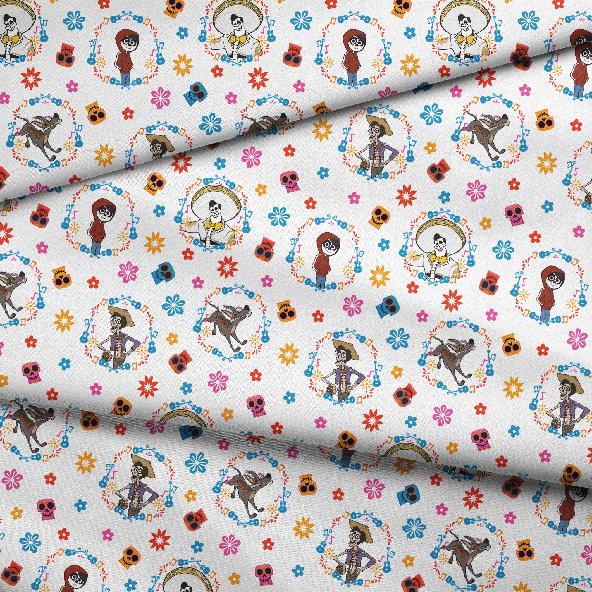 Colorful Coco pattern with Day of the Dead skeleton characters in floral wreaths, sugar skulls, and bright flowers on white background fabric fold mockup