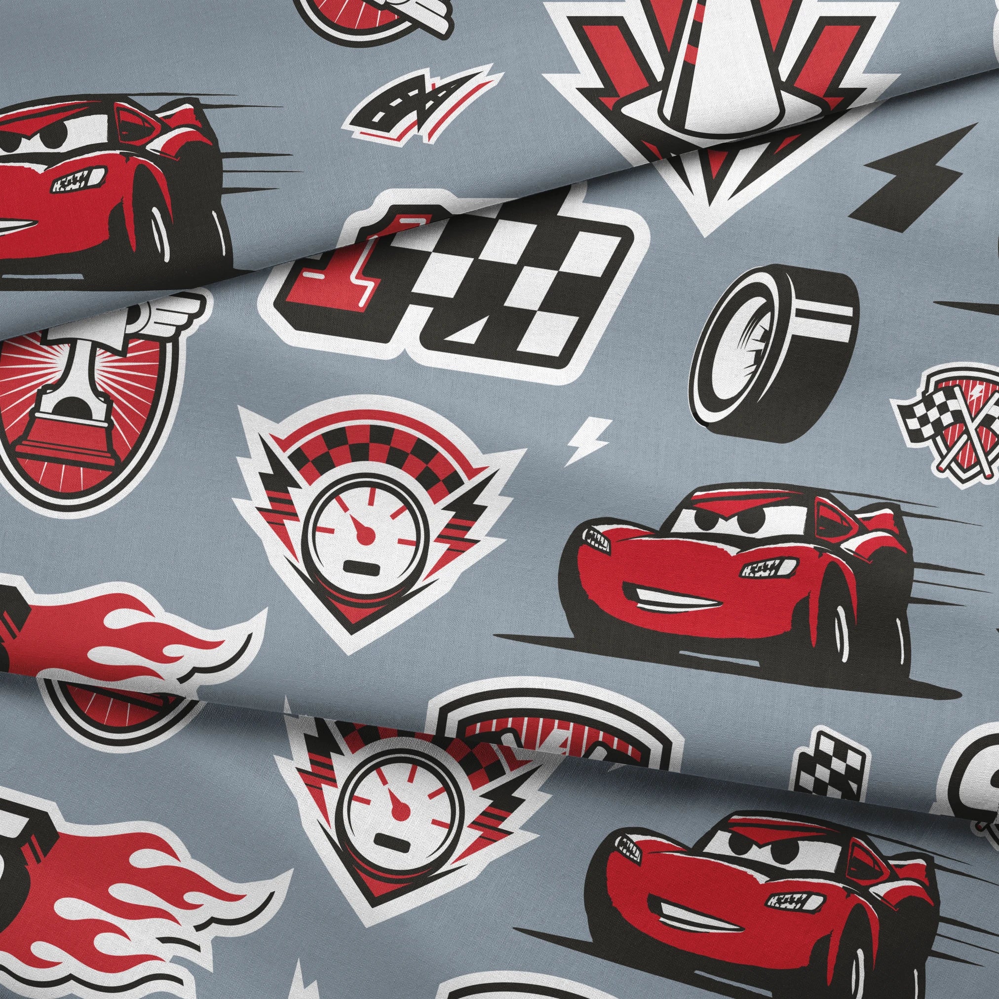Racing pattern with red cars, checkered flags, speedometers, and racing emblems on gray background fabric fold mockup