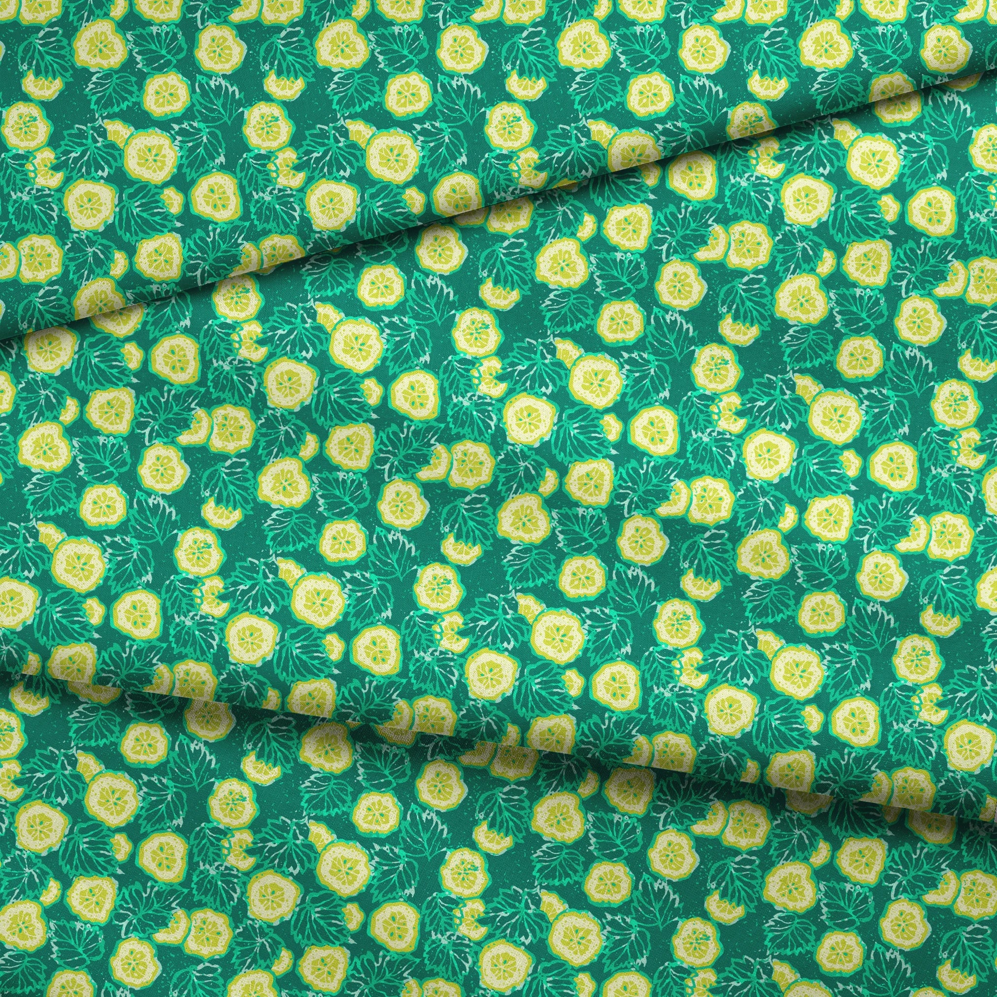Vibrant green background with yellow cucumber slices and light green leafy patterns fabric fold mockup