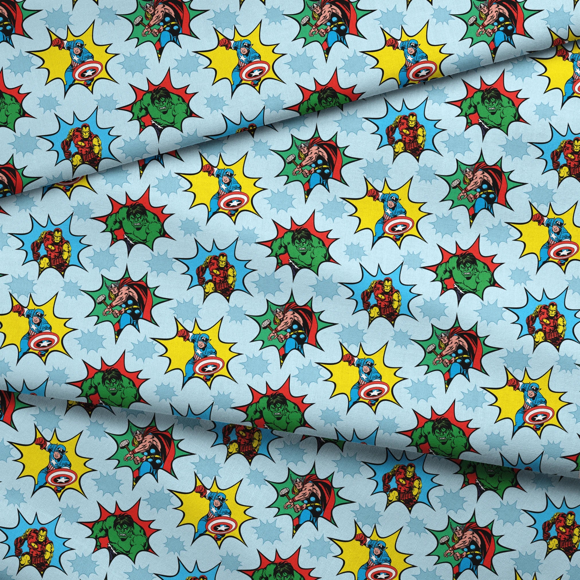 Marvel superhero pattern with Captain America, Iron Man, and Hulk in colorful burst designs on a blue background. fabric fold mockup