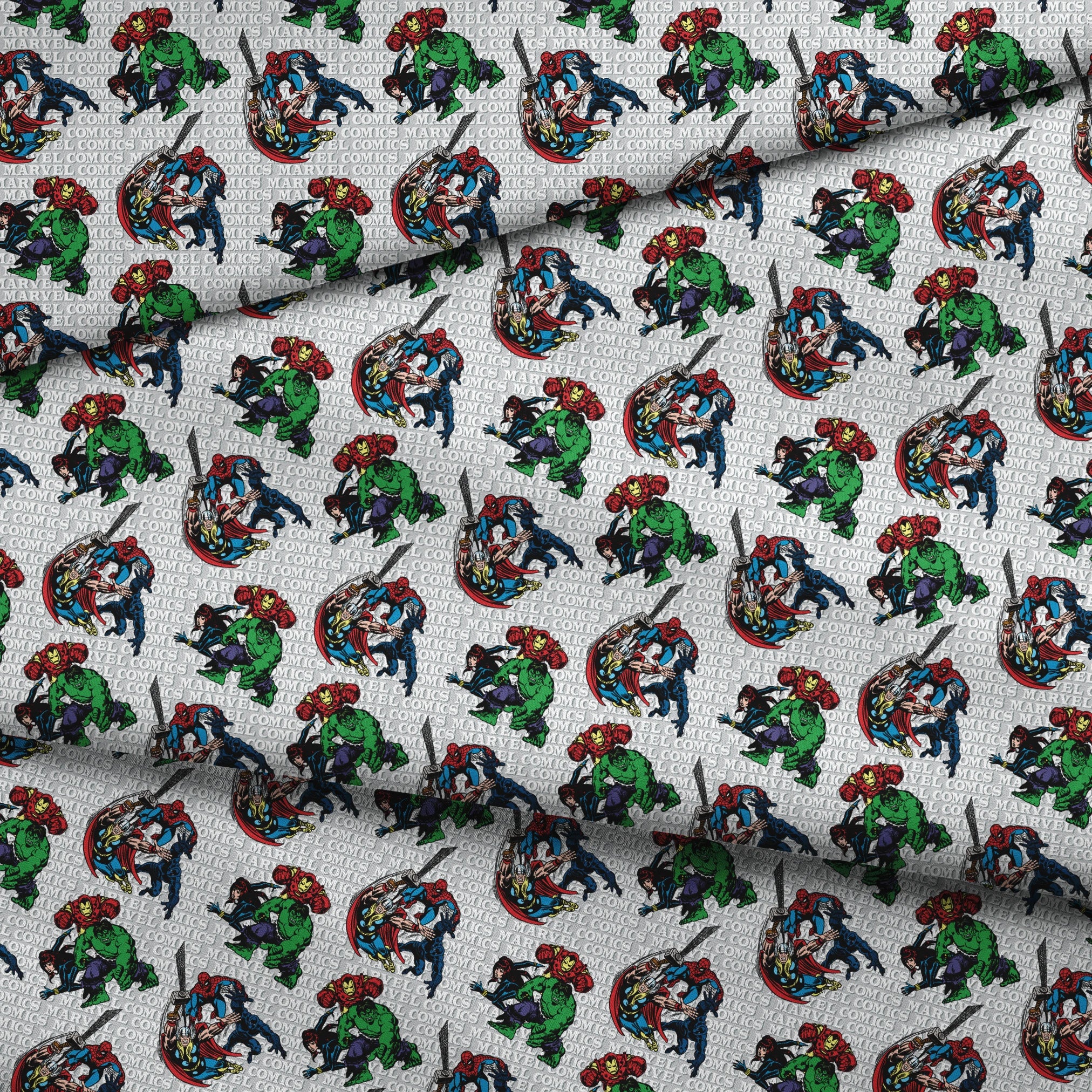 Marvel Comics superheroes pattern with Hulk, Iron Man, Captain America, and Spider-Man on a repeating text background. fabric fold mockup