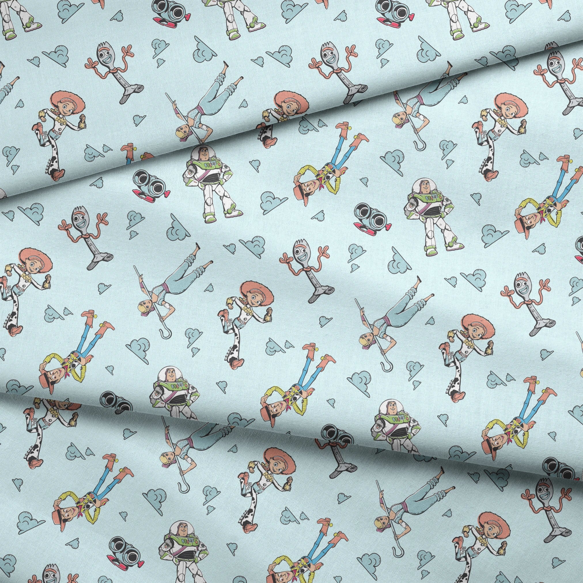 Cartoon characters from "Toy Story" floating on light blue background with cloud patterns fabric fold mockup