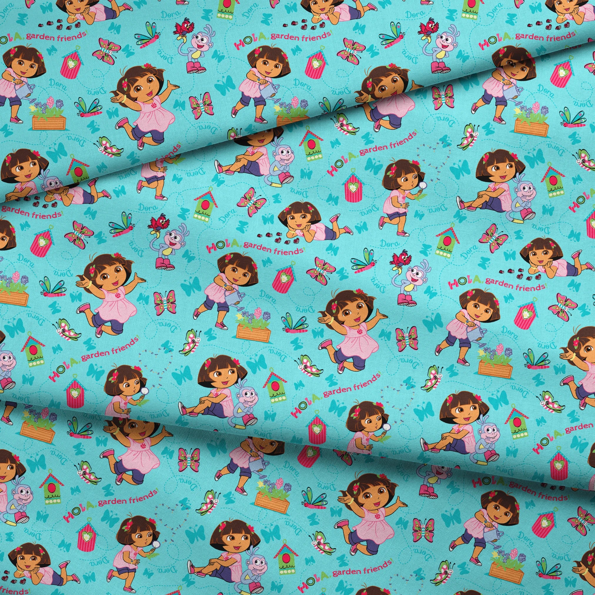 Colorful Dora the Explorer pattern on light blue background fabric fold mockup