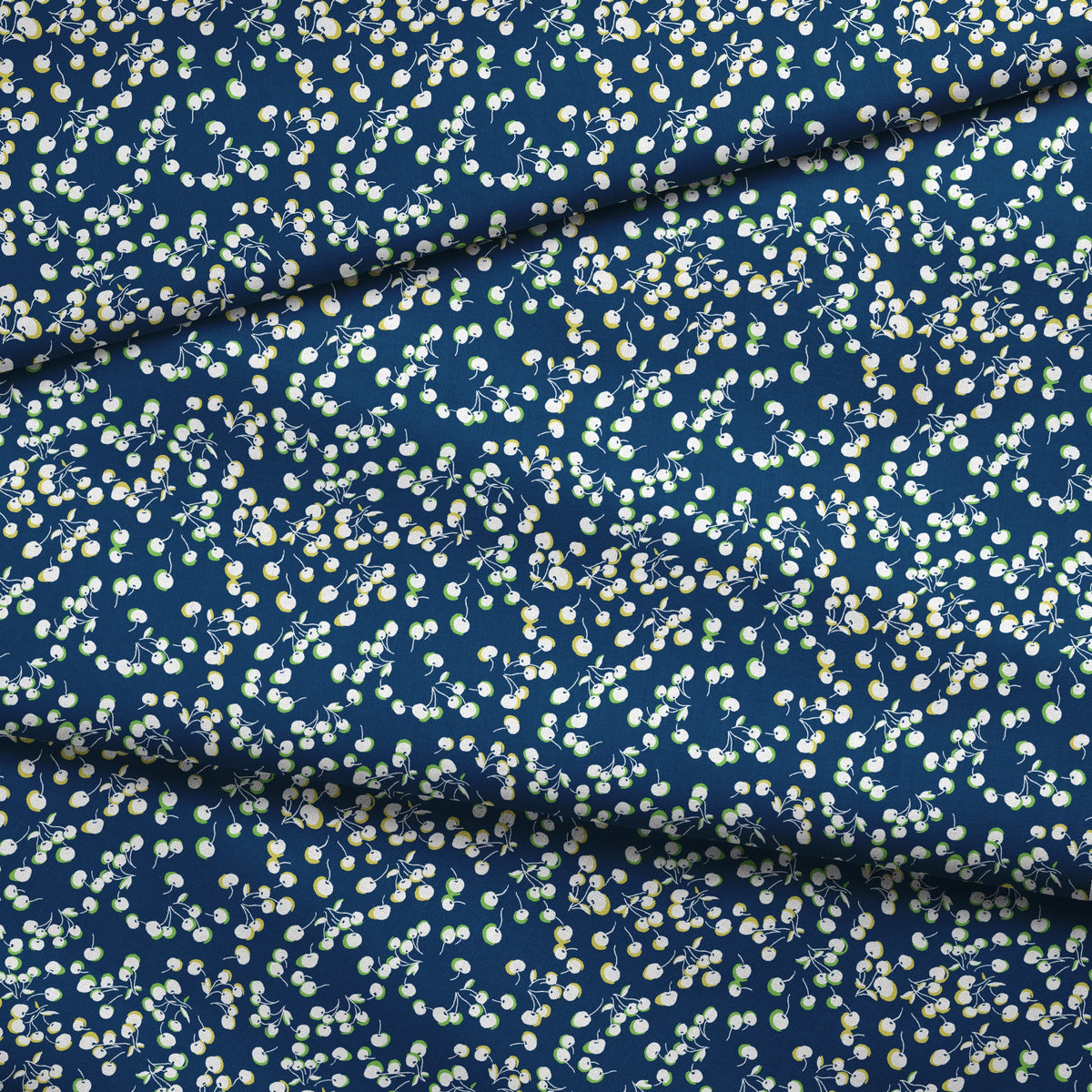 Delicate white and yellow floral pattern scattered across a deep navy blue background fabric fold mockup