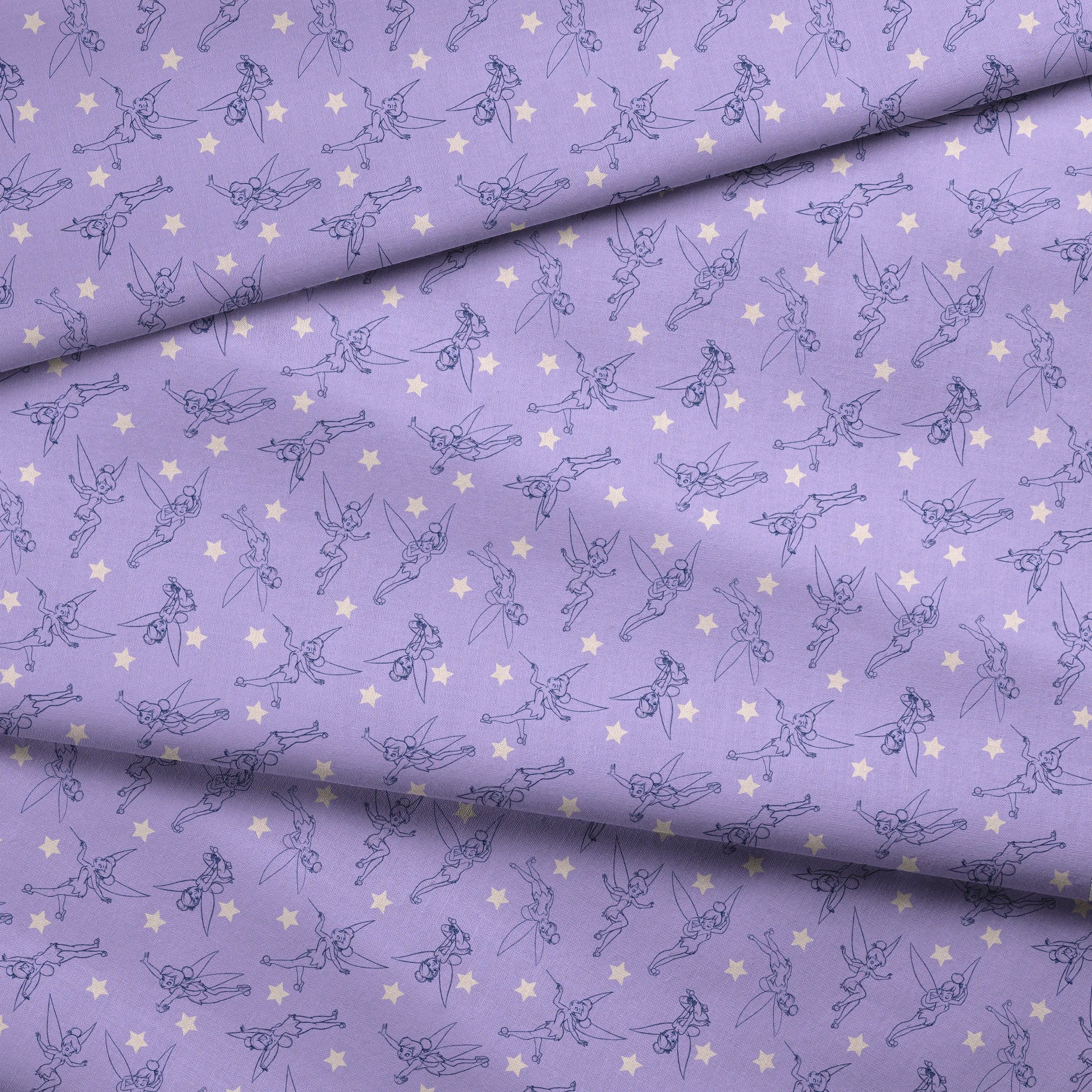 Tinker Bell dancing across a lavender purple background with white stars fabric fold mockup