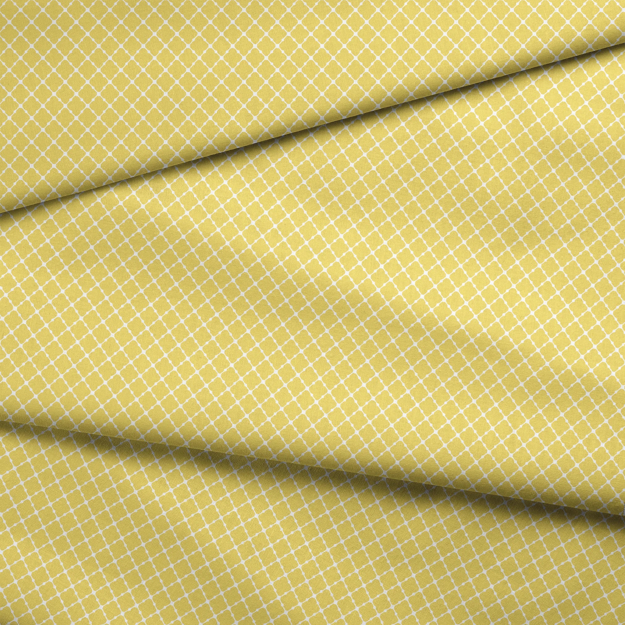Yellow quatrefoil pattern on white background with Moroccan tile inspired design fabric fold mockup