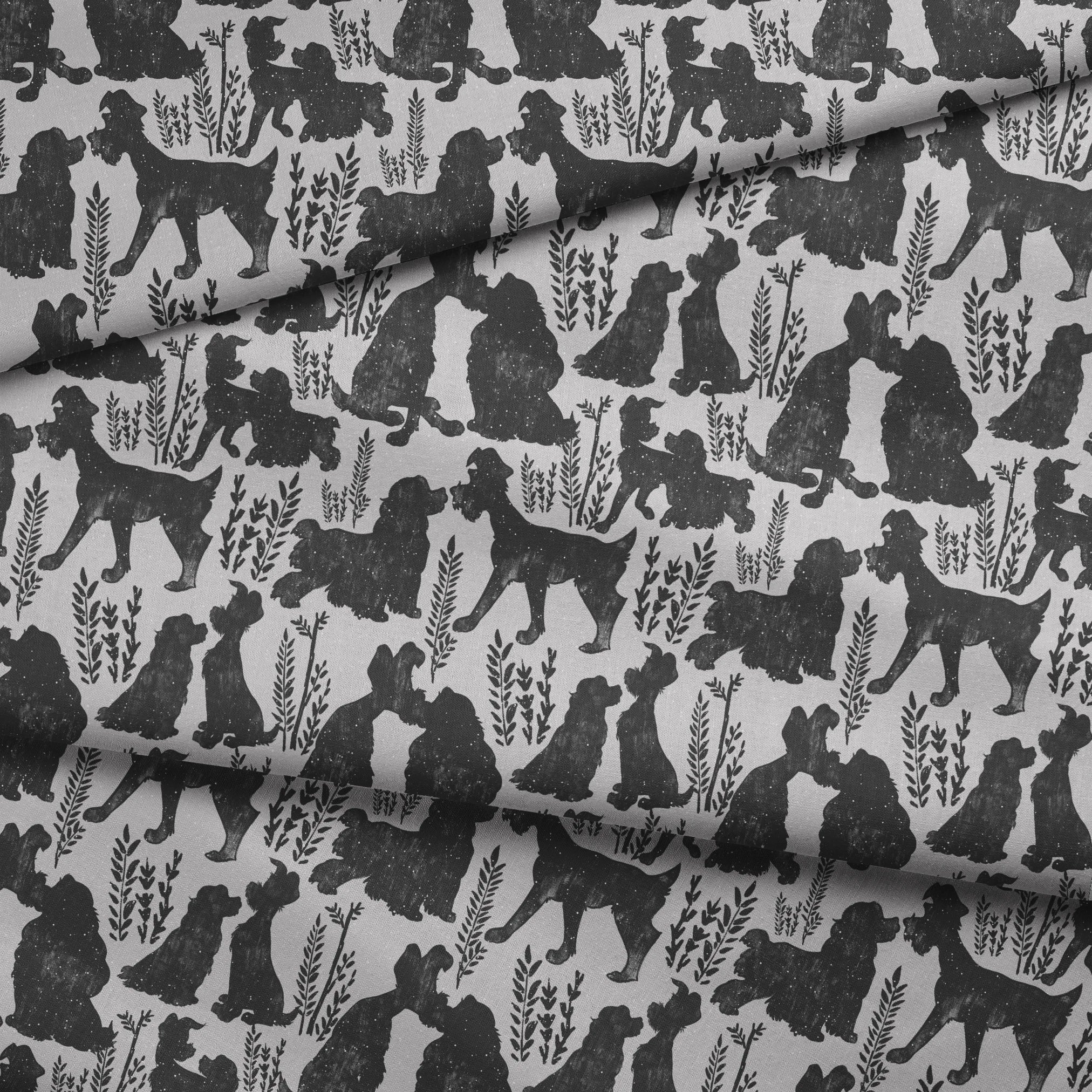 Repeating pattern of black dog silhouettes with decorative plant motifs on a light gray background fabric fold mockup