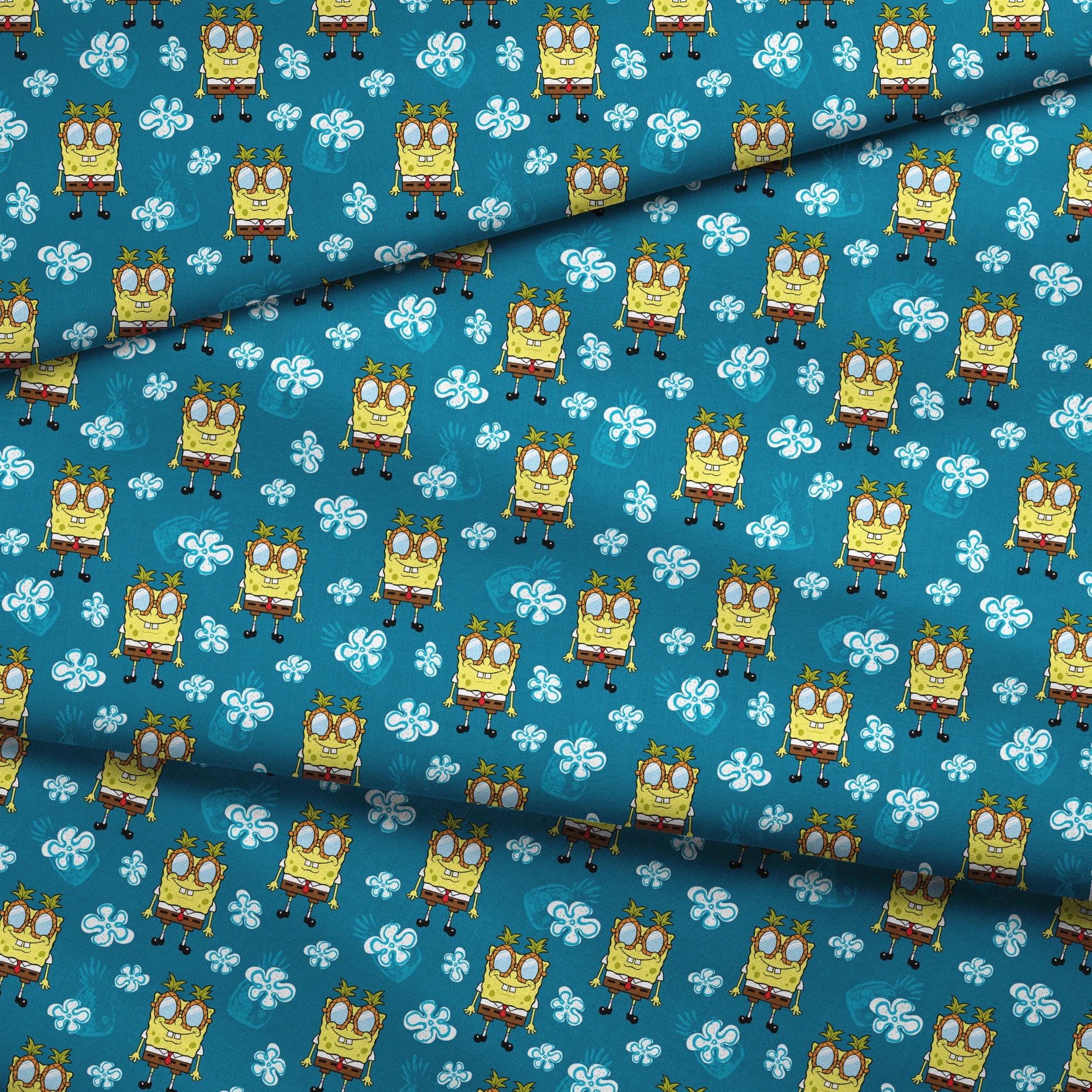 Yellow cartoon character with glasses on teal background with white flower pattern, repeating design fabric fold mockup