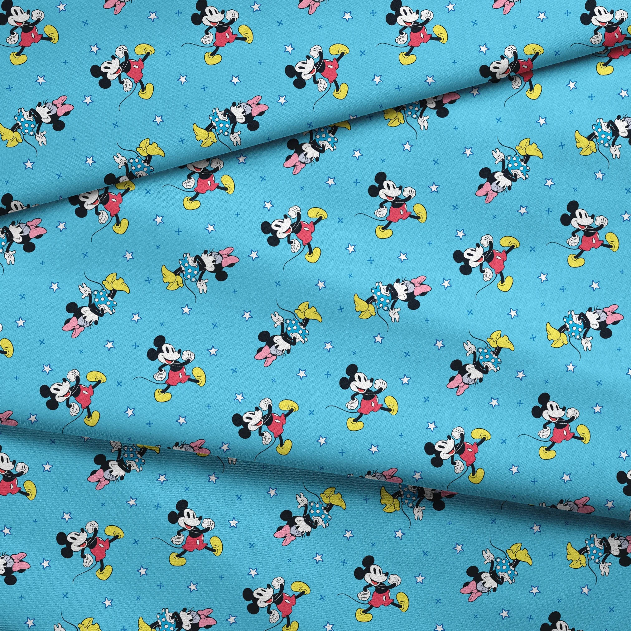 Disney Mickey Mouse and Minnie Mouse characters on light blue background with white stars, pattern design fabric fold mockup