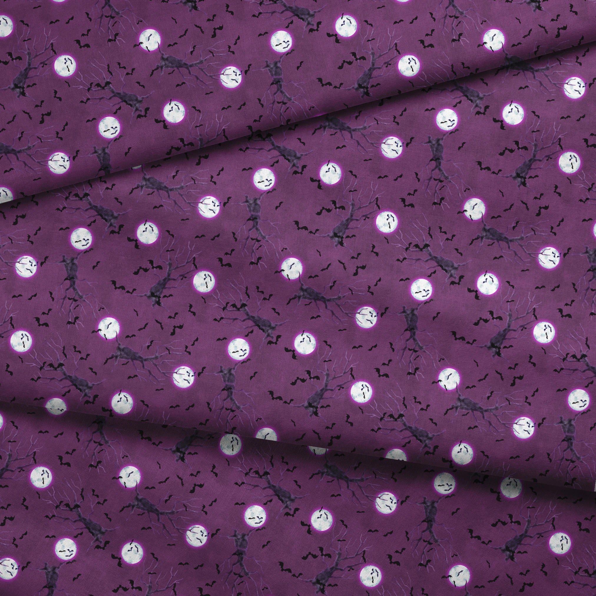 Halloween fabric design with spooky trees, bats, and glowing full moons on a purple background, illustrated by Nicole Tamarin. fabric fold mockup