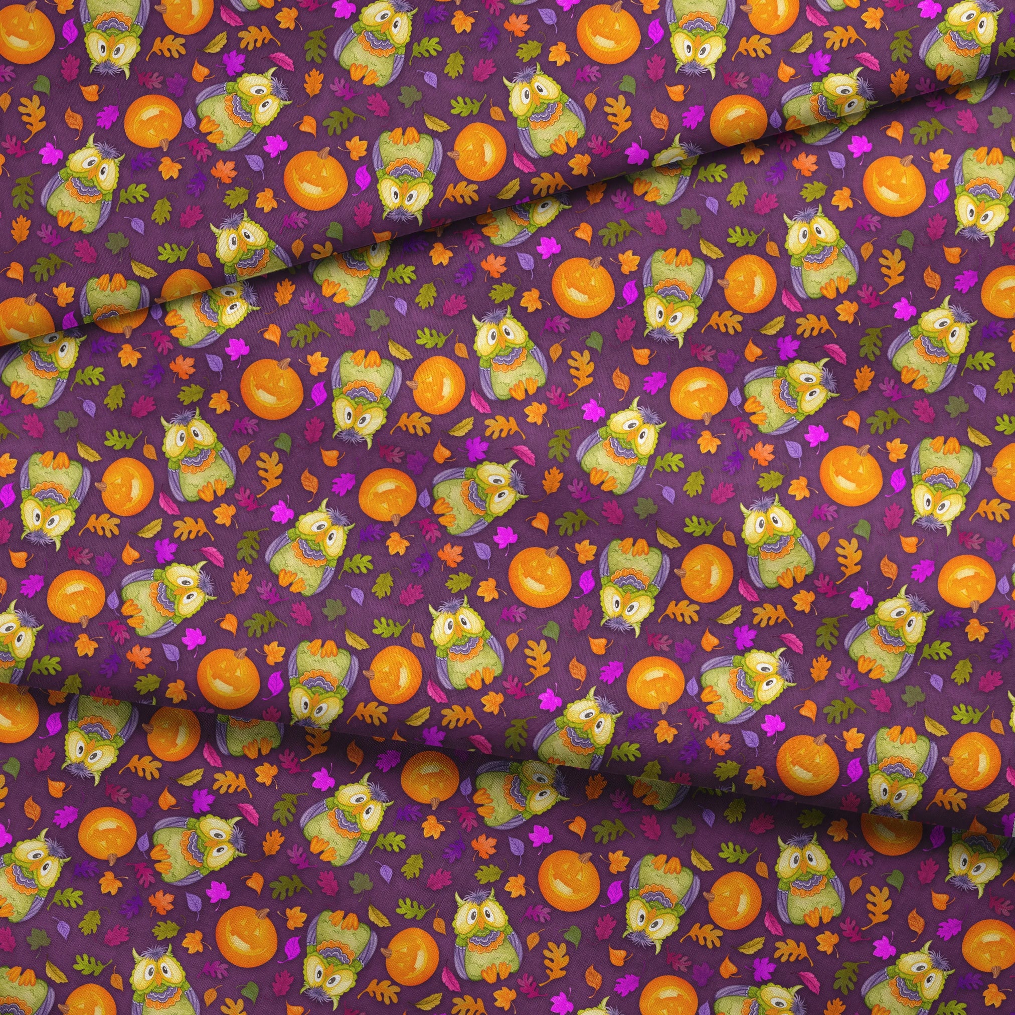 Halloween fabric by Nicole Tamarin featuring cartoon owls in costume, jack-o’-lanterns, and colorful fall leaves on a purple background. fabric fold mockup