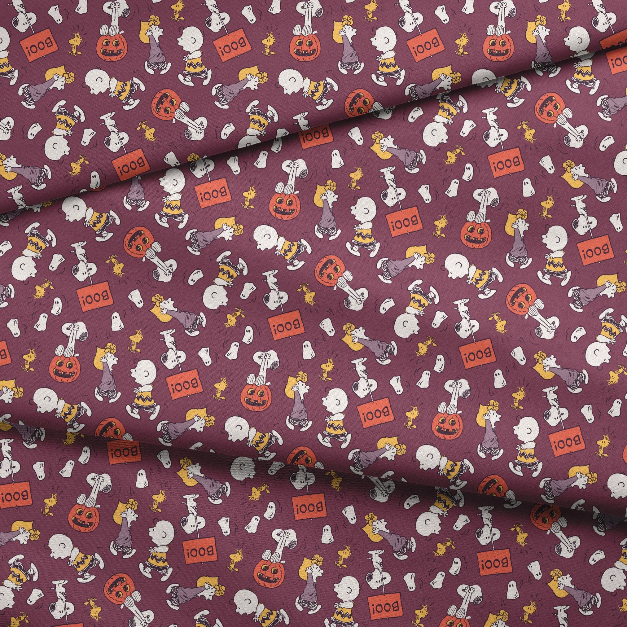 Snoopy and Woodstock Halloween pattern on purple background with pumpkins, ghosts, and "boo!" text fabric fold mockup