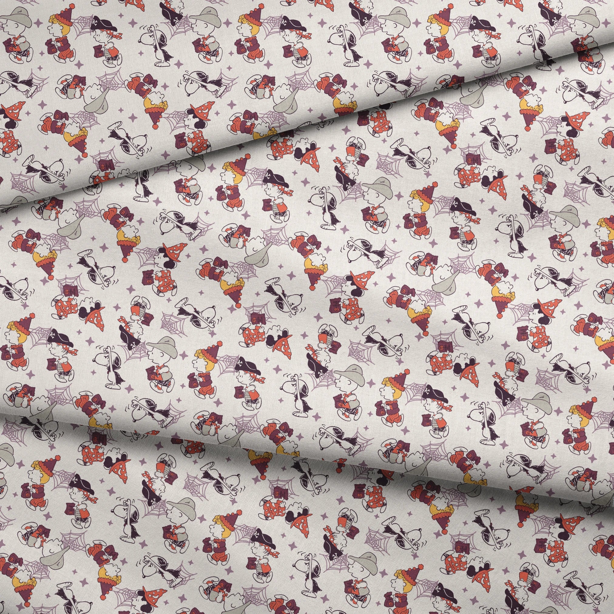 Peanuts characters in Halloween costumes including Snoopy, Charlie Brown, and friends on white background fabric fold mockup