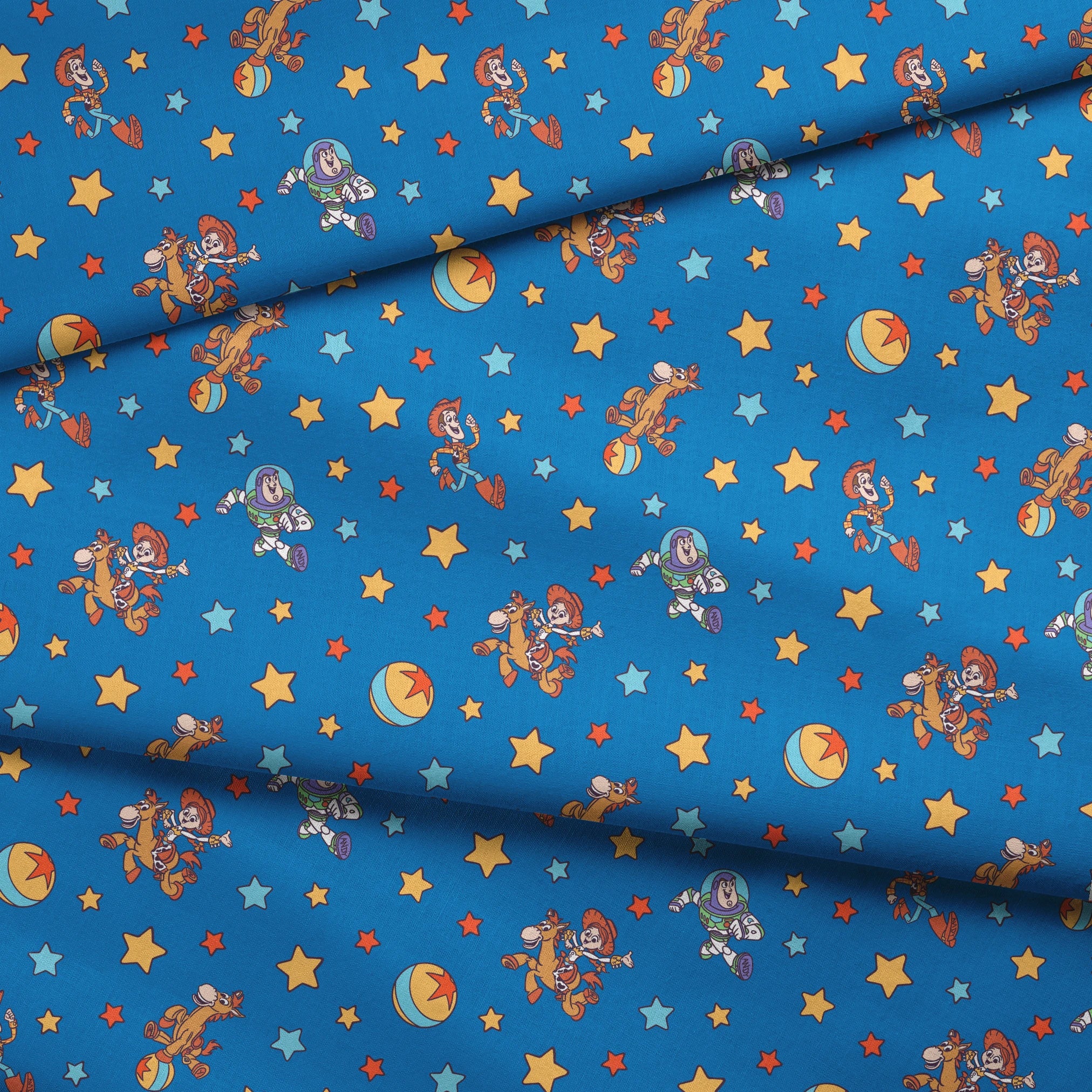 Toy Story characters floating in space pattern with stars on blue background fabric fold mockup
