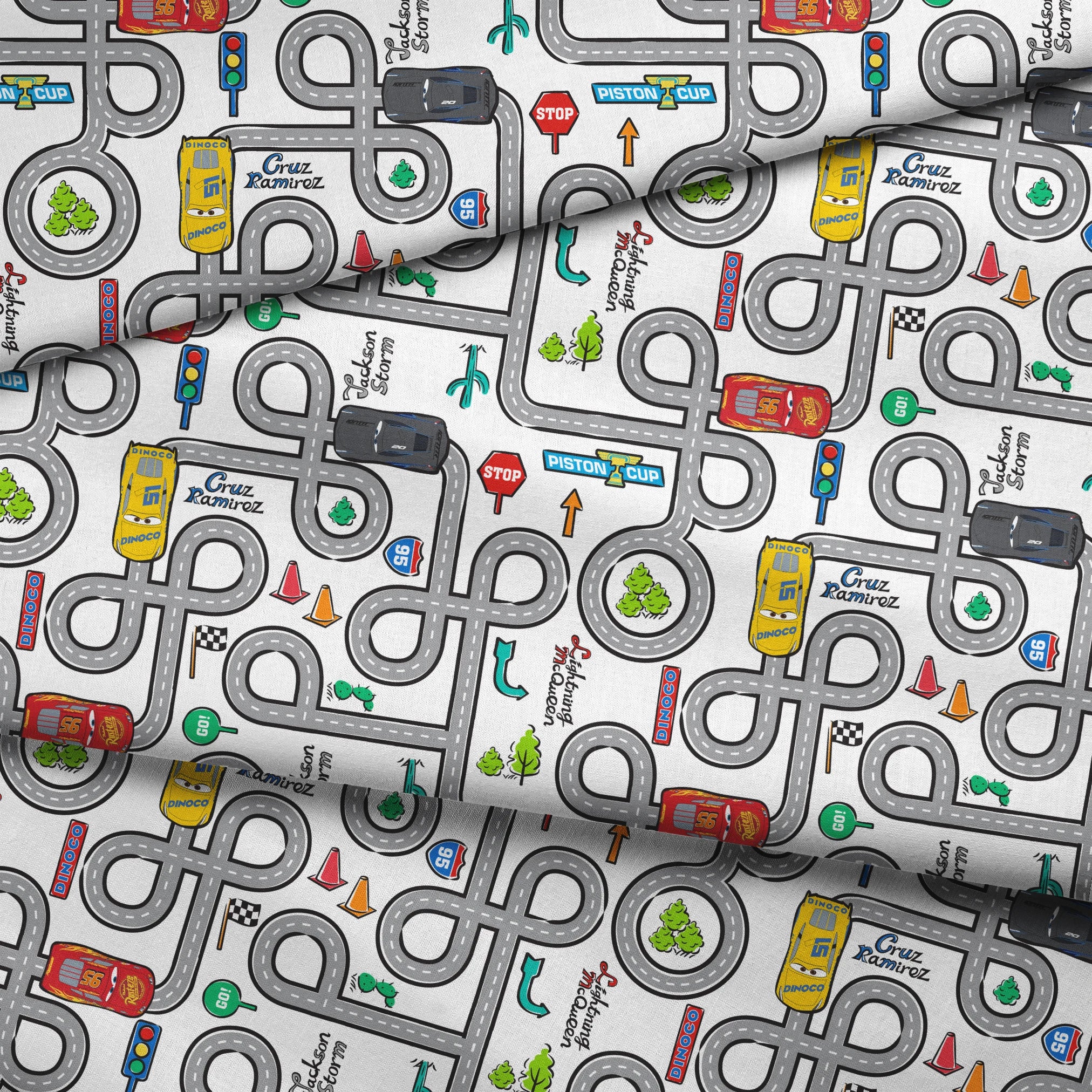 Cartoon road map with cars, traffic signs, and "Cruz Ramirez" label on winding gray streets fabric fold mockup