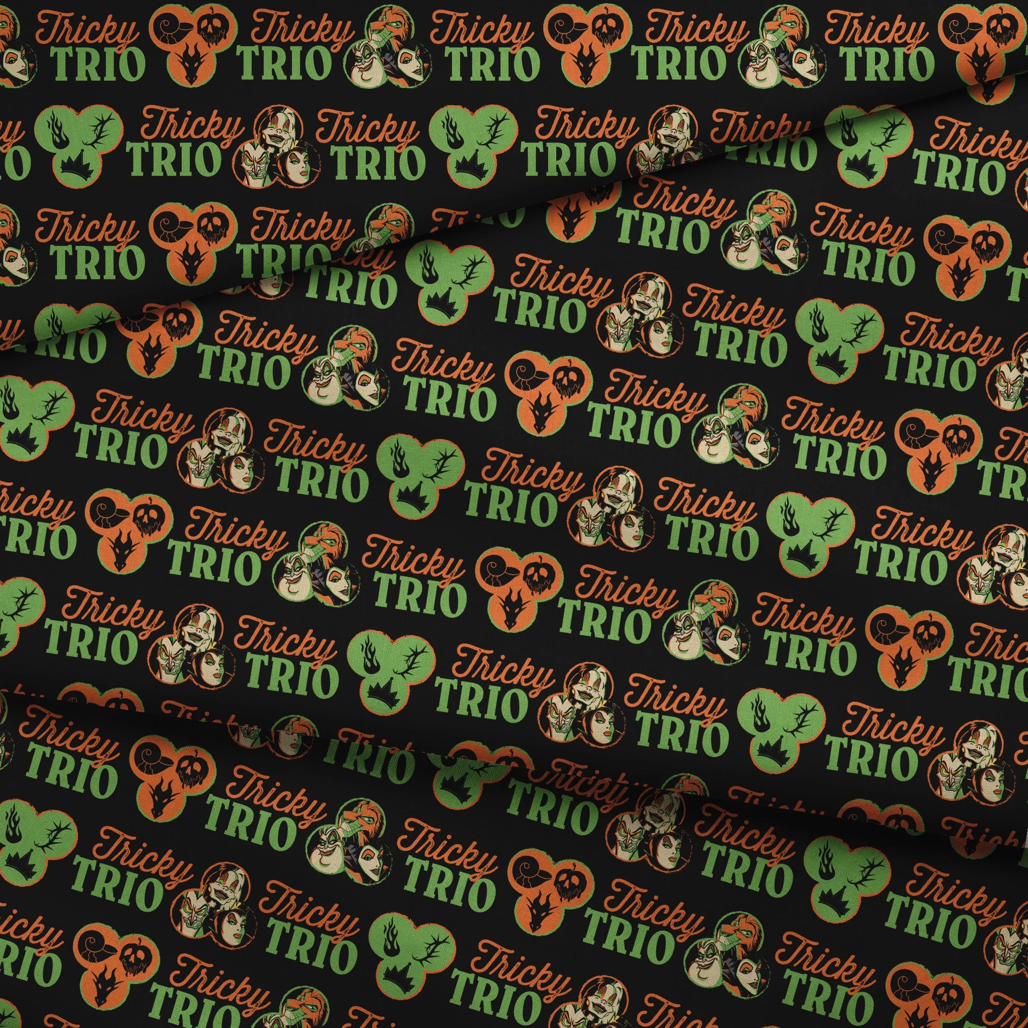 Disney Halloween pattern with "Tricky TRIO" text in orange and green, featuring Disney Villains, pumpkins, and ghostly designs on black background fabric fold mockup