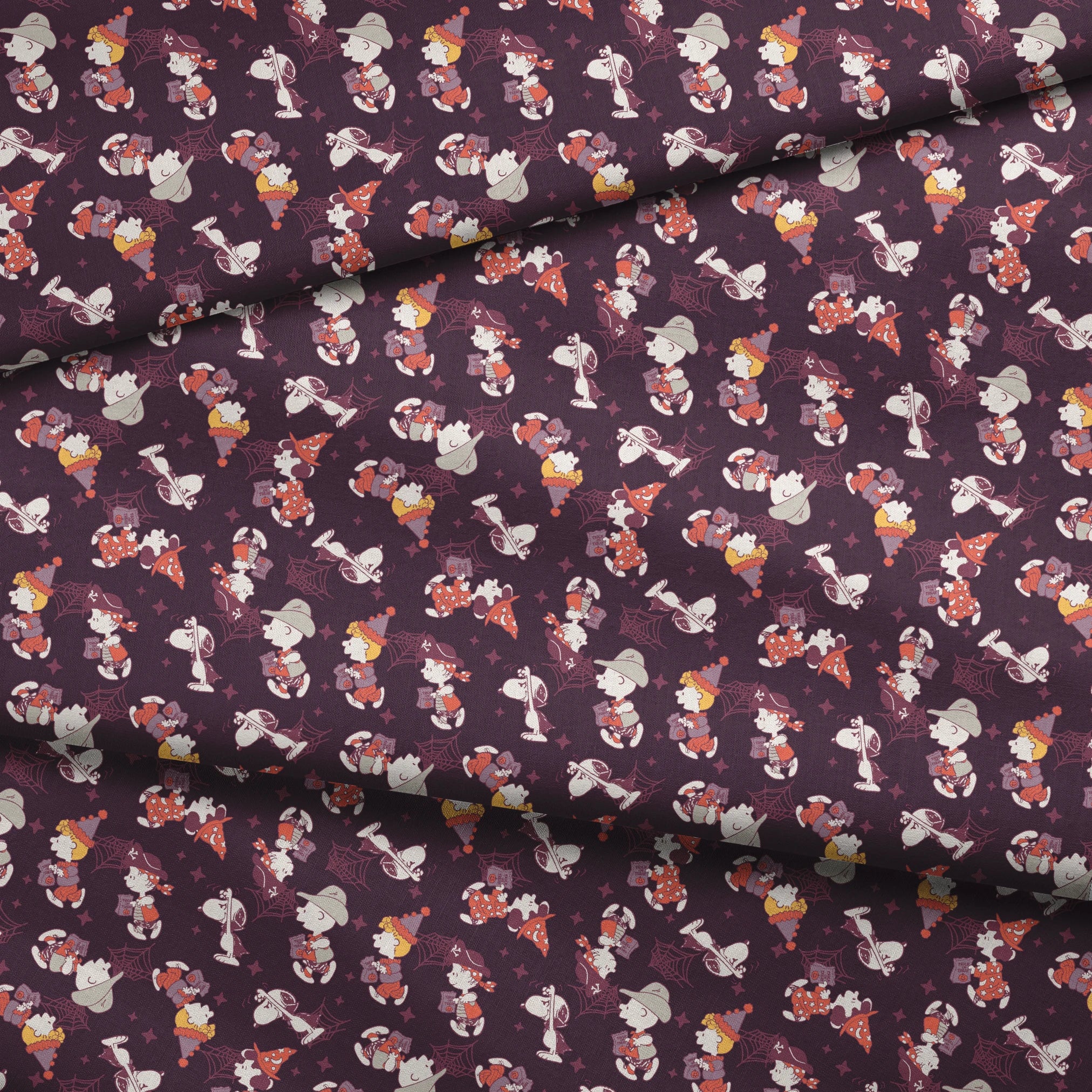 Snoopy and Peanuts characters in Halloween costumes scattered on dark purple background fabric fold mockup