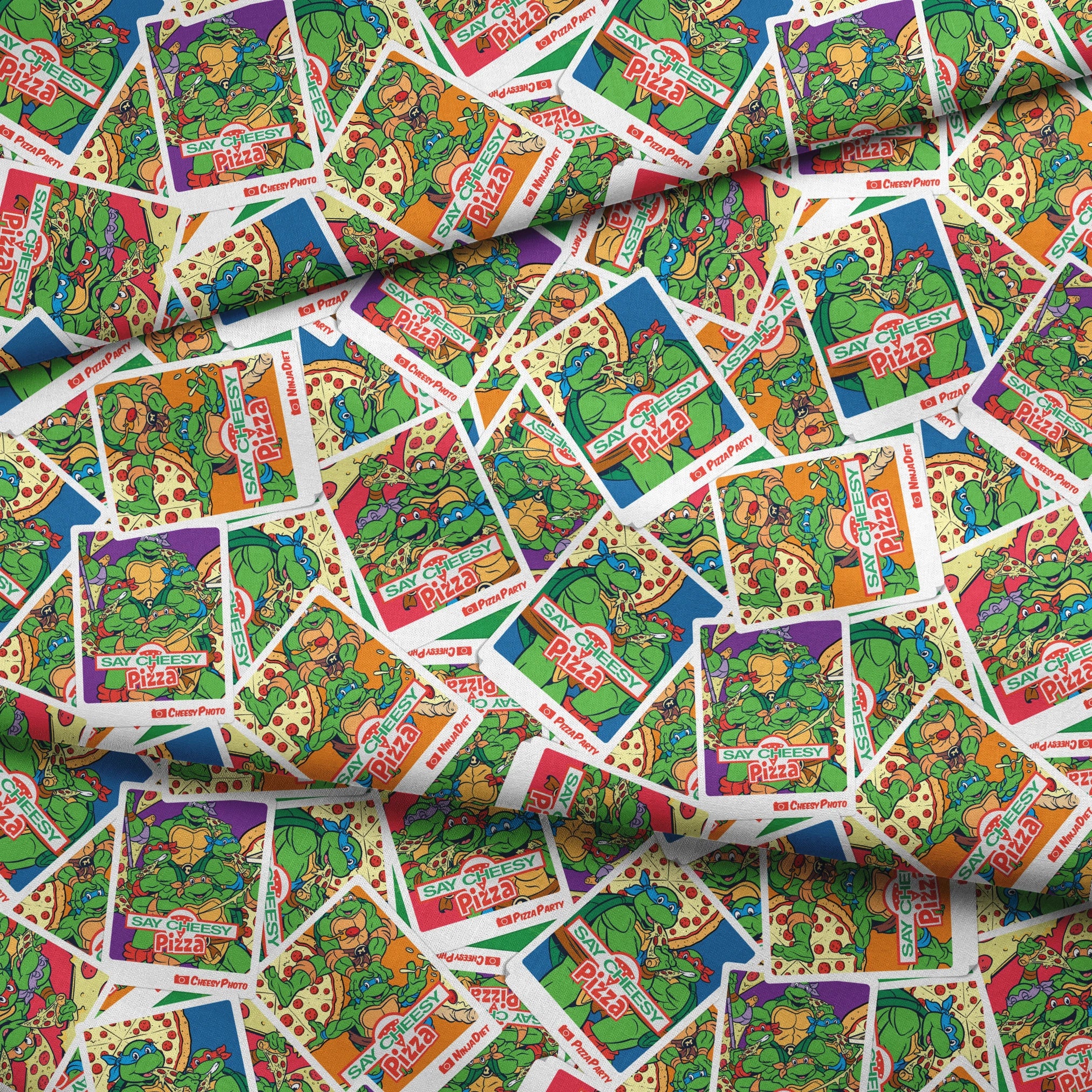 Scattered vintage Teenage Mutant Ninja Turtles trading cards with colorful comic-style artwork fabric fold mockup