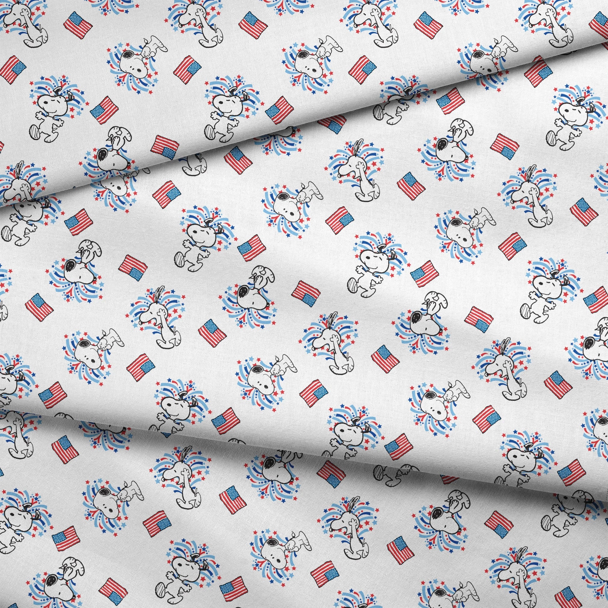 Snoopy with red and blue fireworks pattern alongside American flags on white background fabric fold mockup