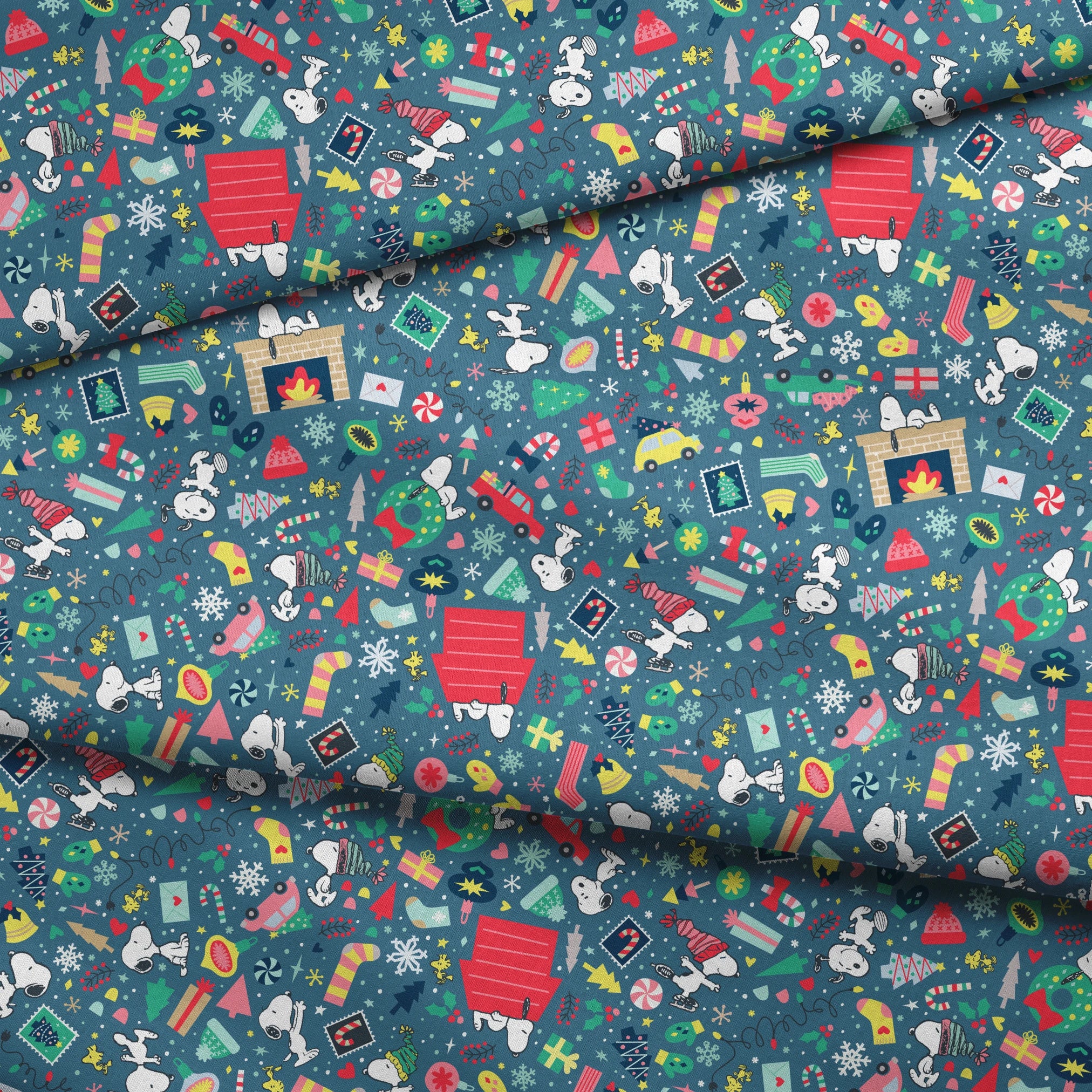 Colorful Peanuts Christmas pattern with festive icons, red mailboxes, presents, houses, and holiday symbols on teal background fabric fold mockup