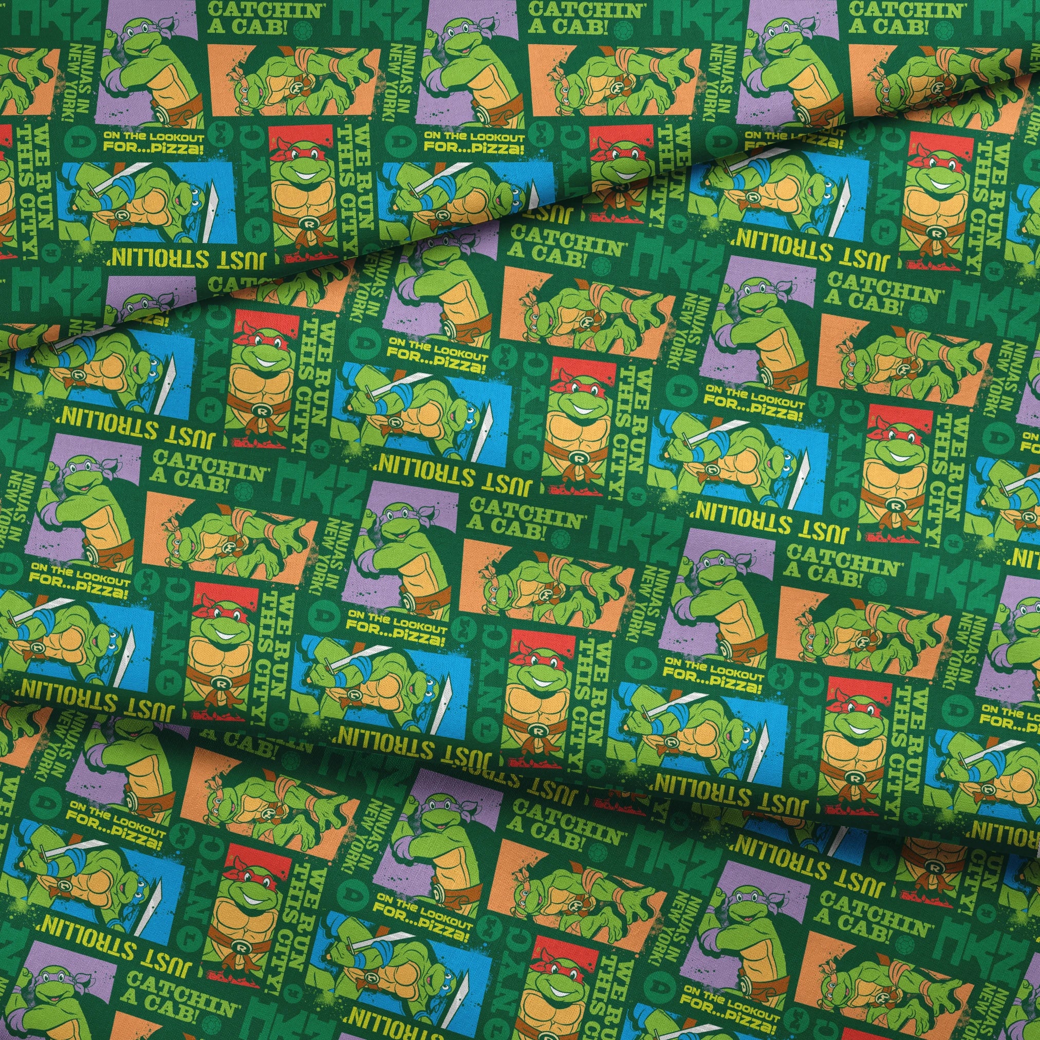 Teenage Mutant Ninja Turtles comic-style panels with phrases like "Catchin' a cab!" and "On the lookout for pizza!" on green background fabric fold mockup