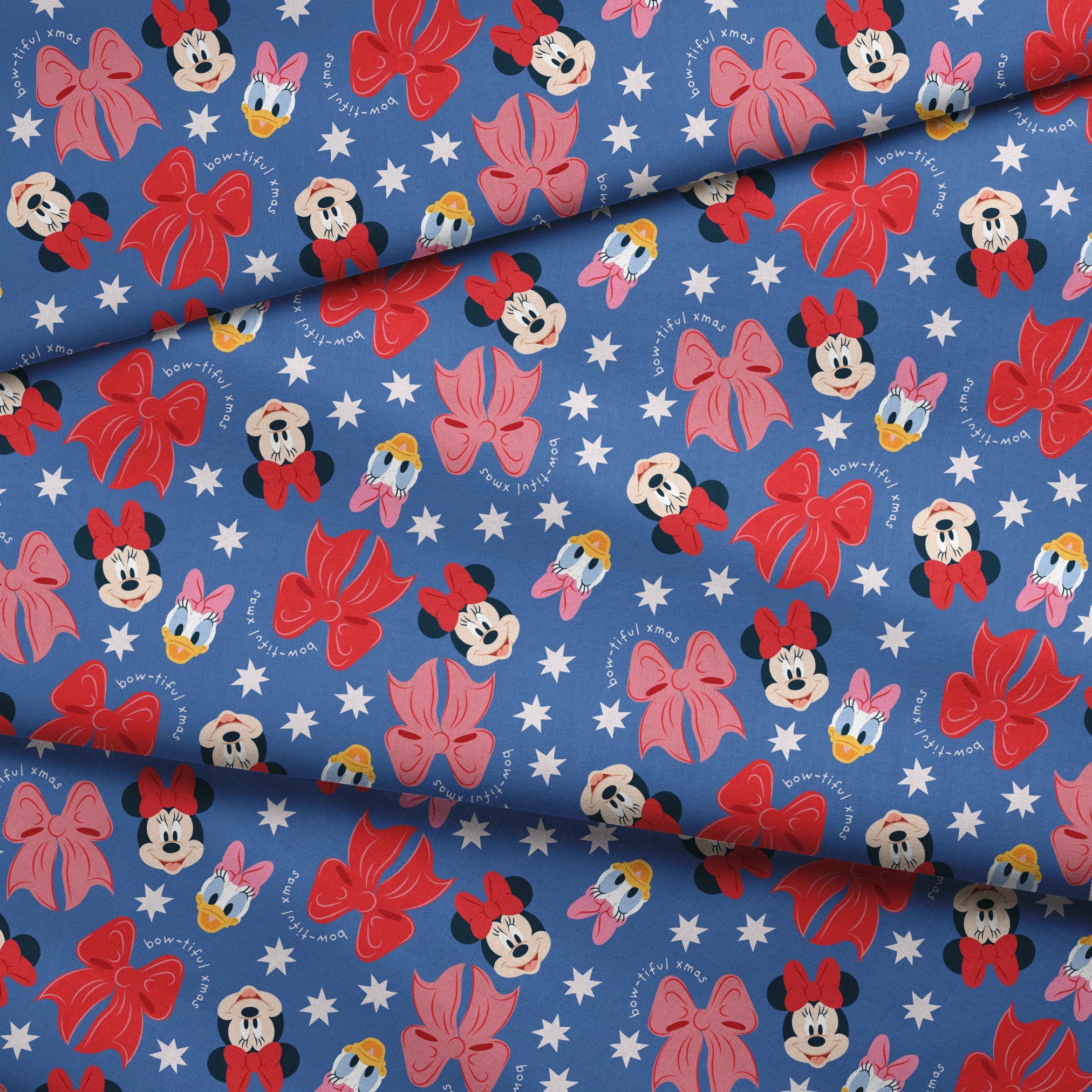 Disney character pattern with Minnie Mouse, Daisy Duck, and pink/red bows on blue background with white stars fabric fold mockup