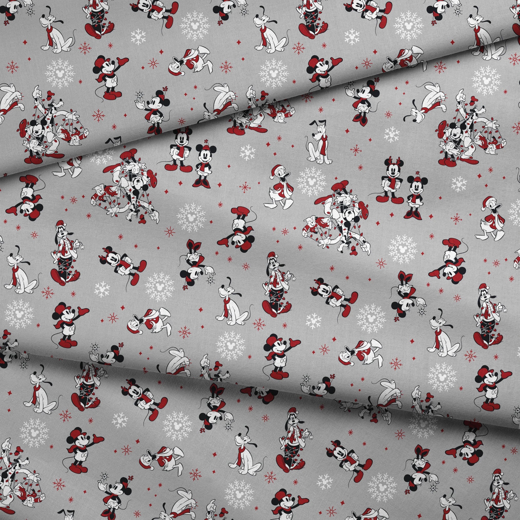 Mickey and Minnie Mouse characters in winter attire with snowflakes on gray background fabric fold mockup