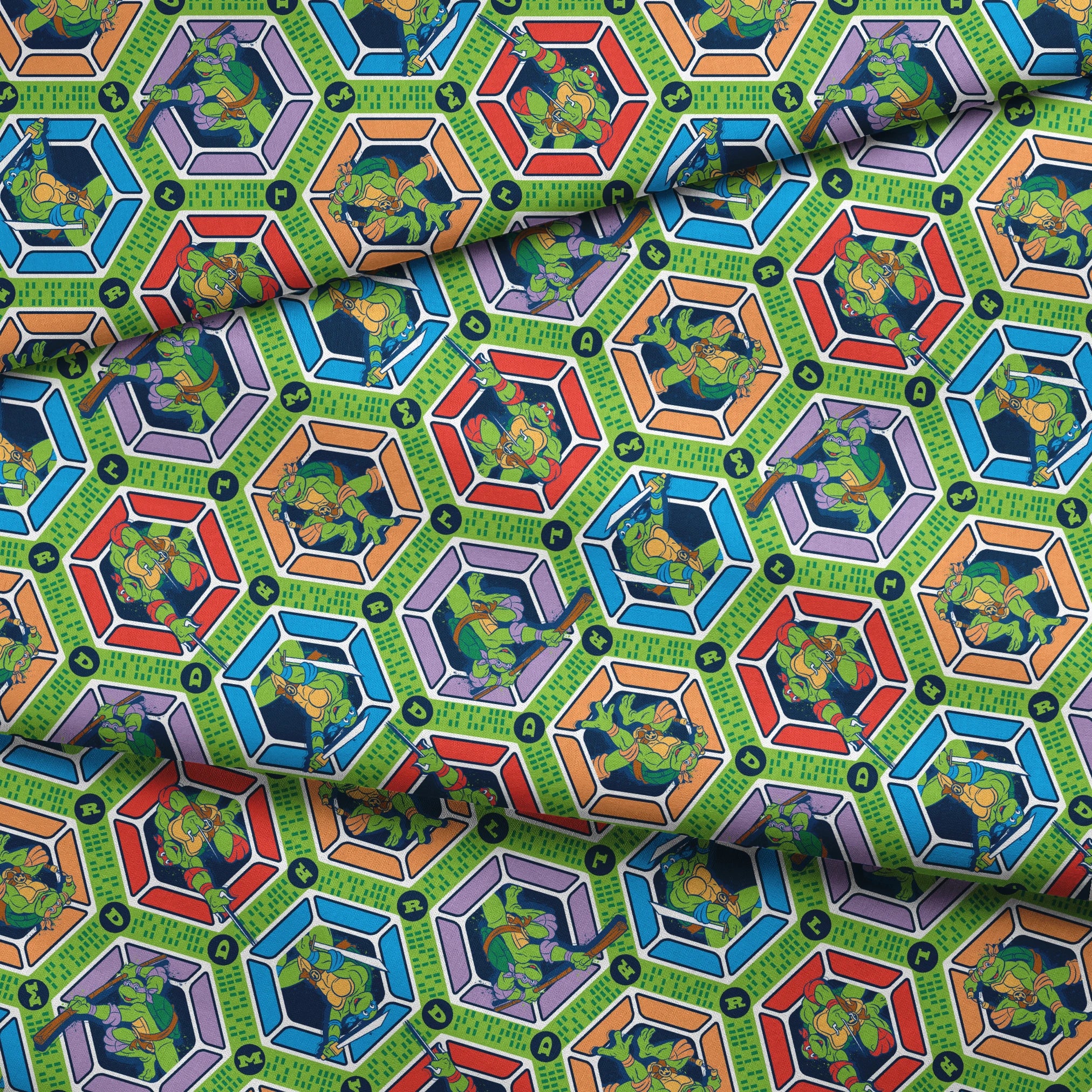 Colorful hexagonal pattern with Teenage Mutant Ninja Turtles and green text strips on blue background fabric fold mockup