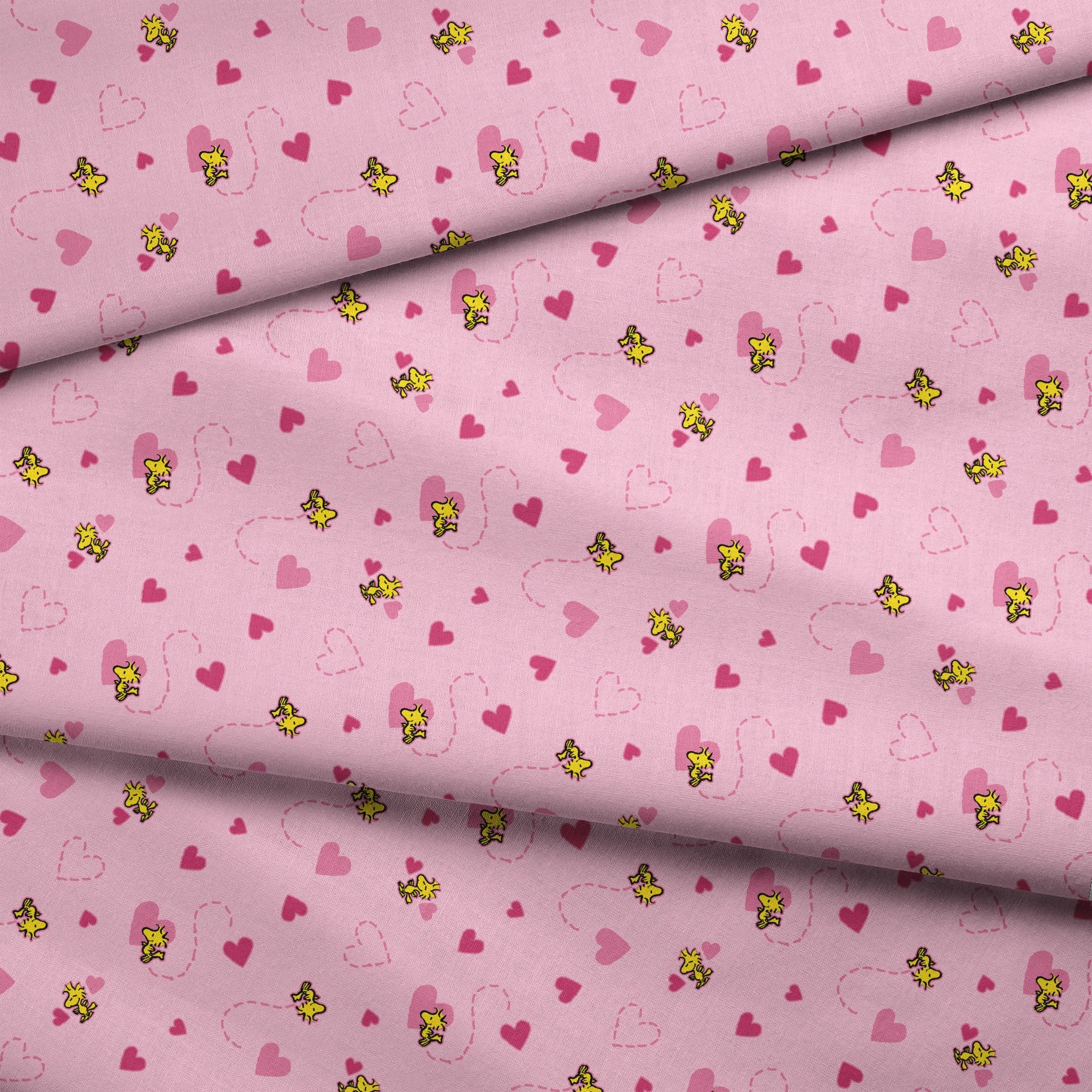 Pink background with hearts and Woodstock pattern, dotted heart outlines and solid pink hearts scattered throughout. fabric fold mockup