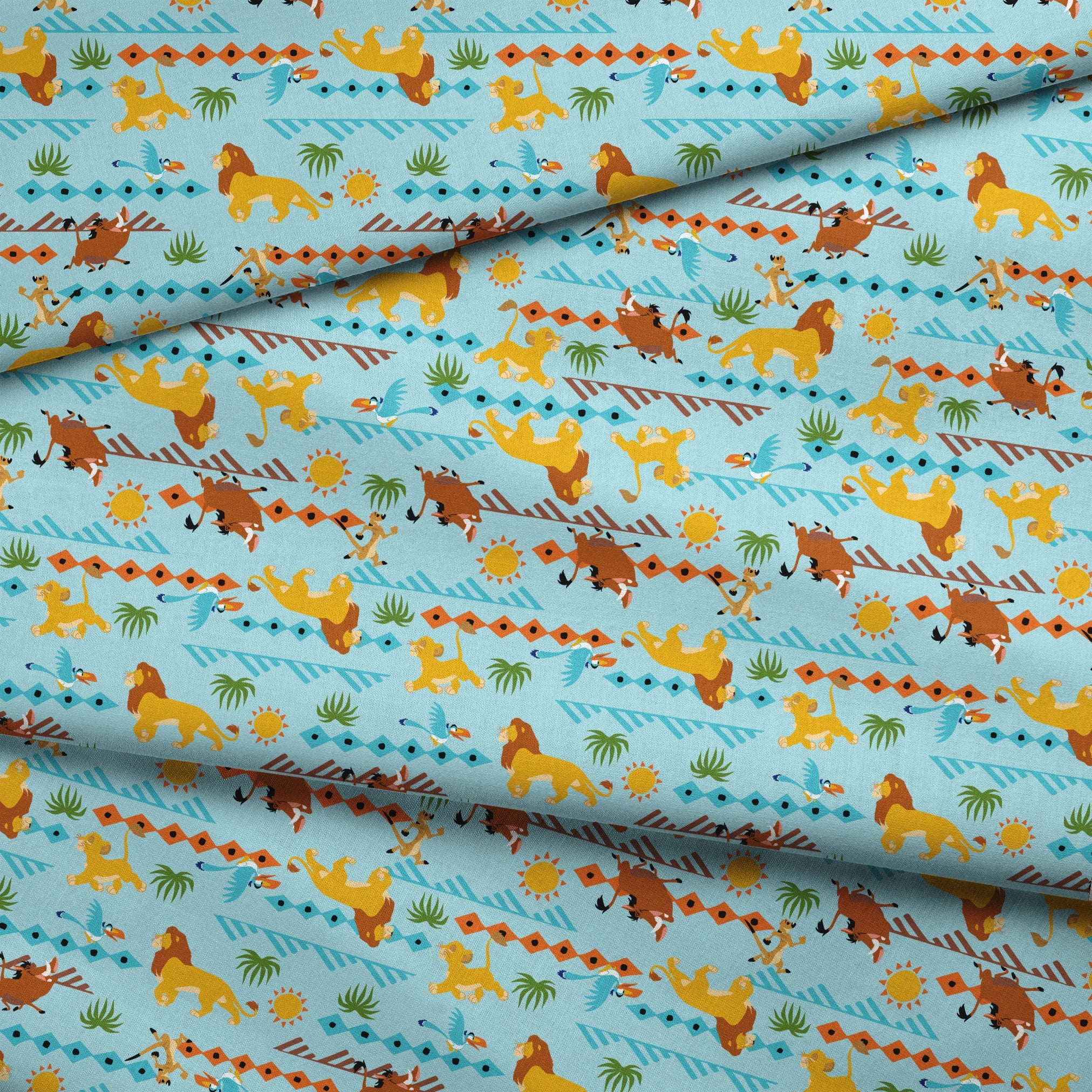 Colorful pattern with cartoon lions, palm trees, and sun designs on a light blue background fabric fold mockup