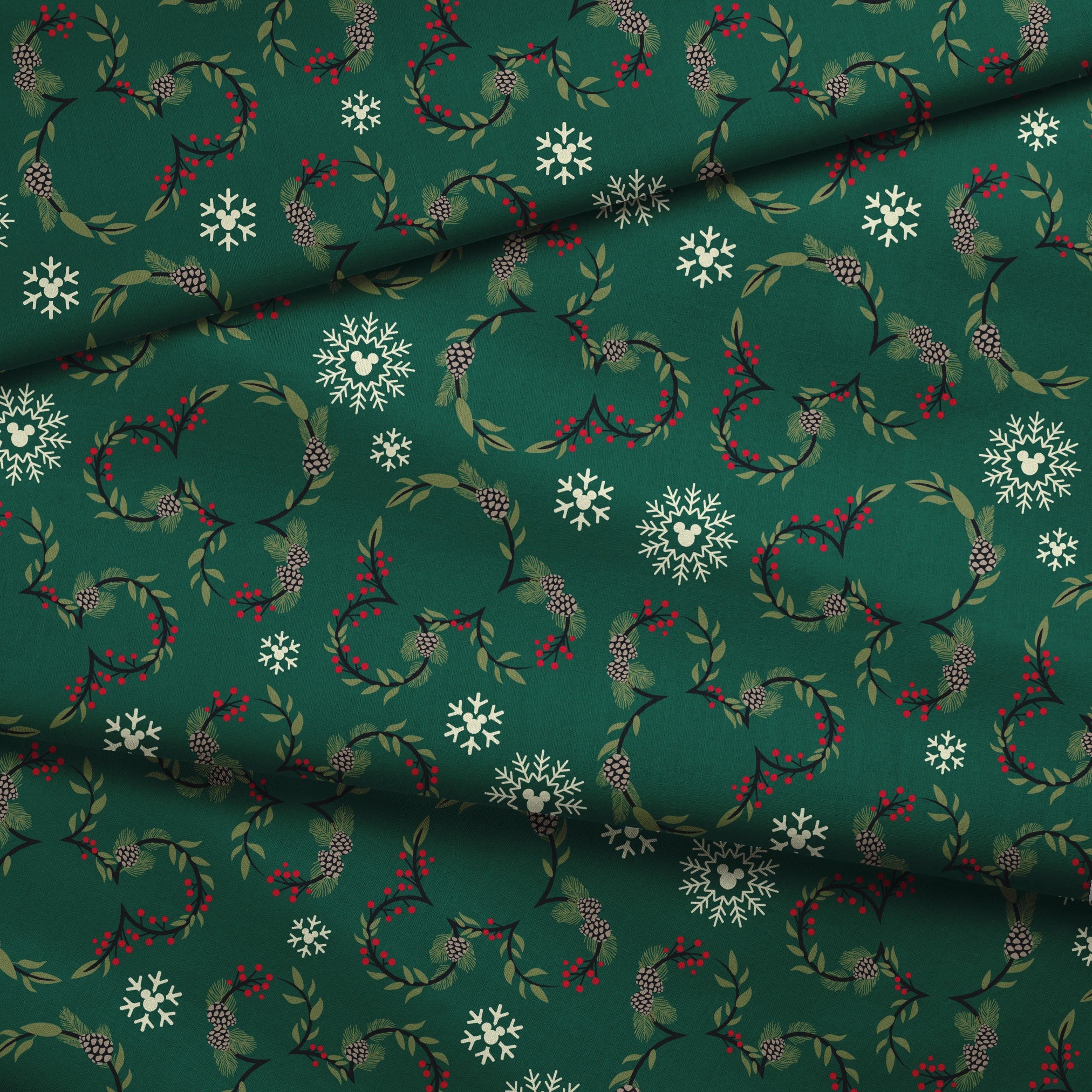 Holiday pattern with green wreaths, pinecones, red berries and white snowflakes on dark green background fabric fold mockup