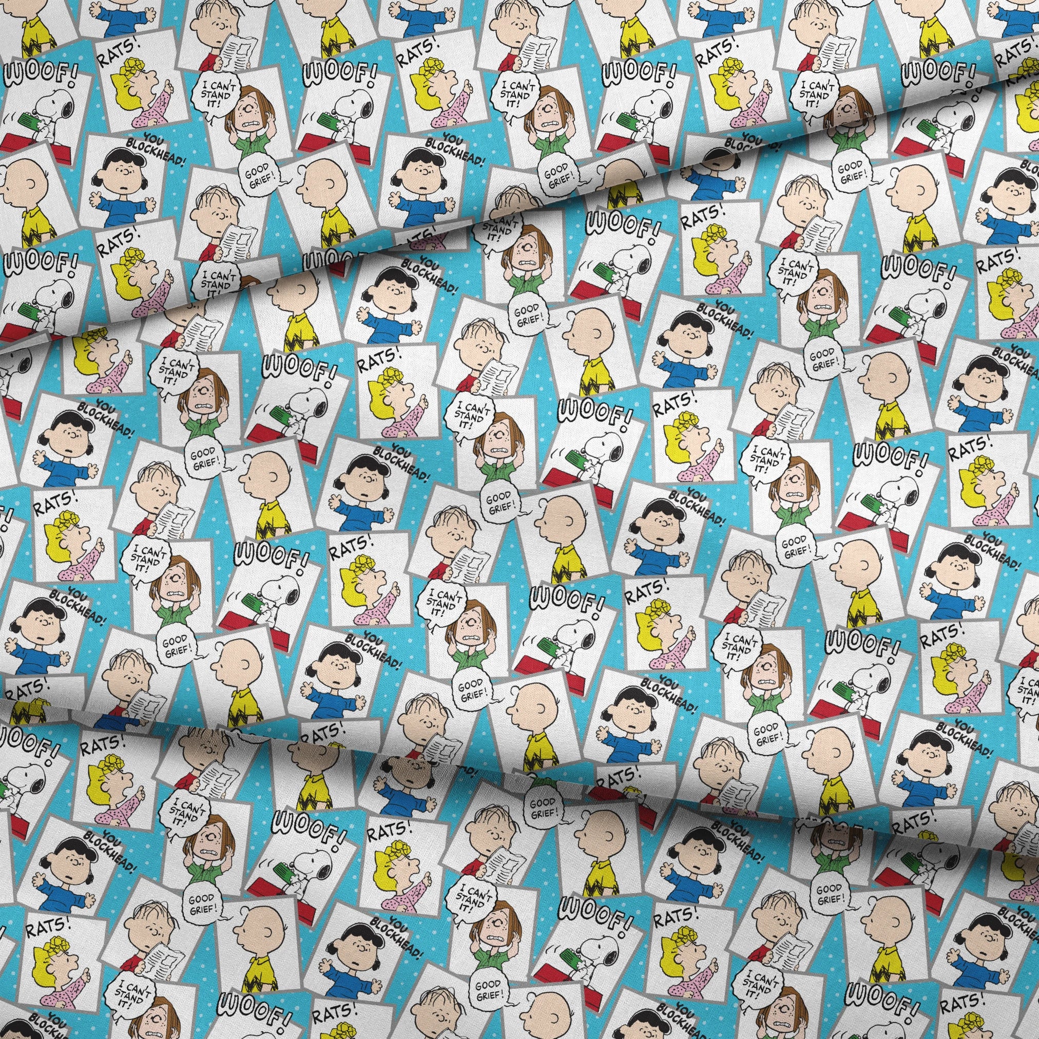 Peanuts comic characters in various expressions - Snoopy saying "WOOF!", speech bubbles with "RATS!", "I CAN'T STAND IT!", "YOU BLOCKHEAD!" and "GOOD GRIEF! fabric fold mockup