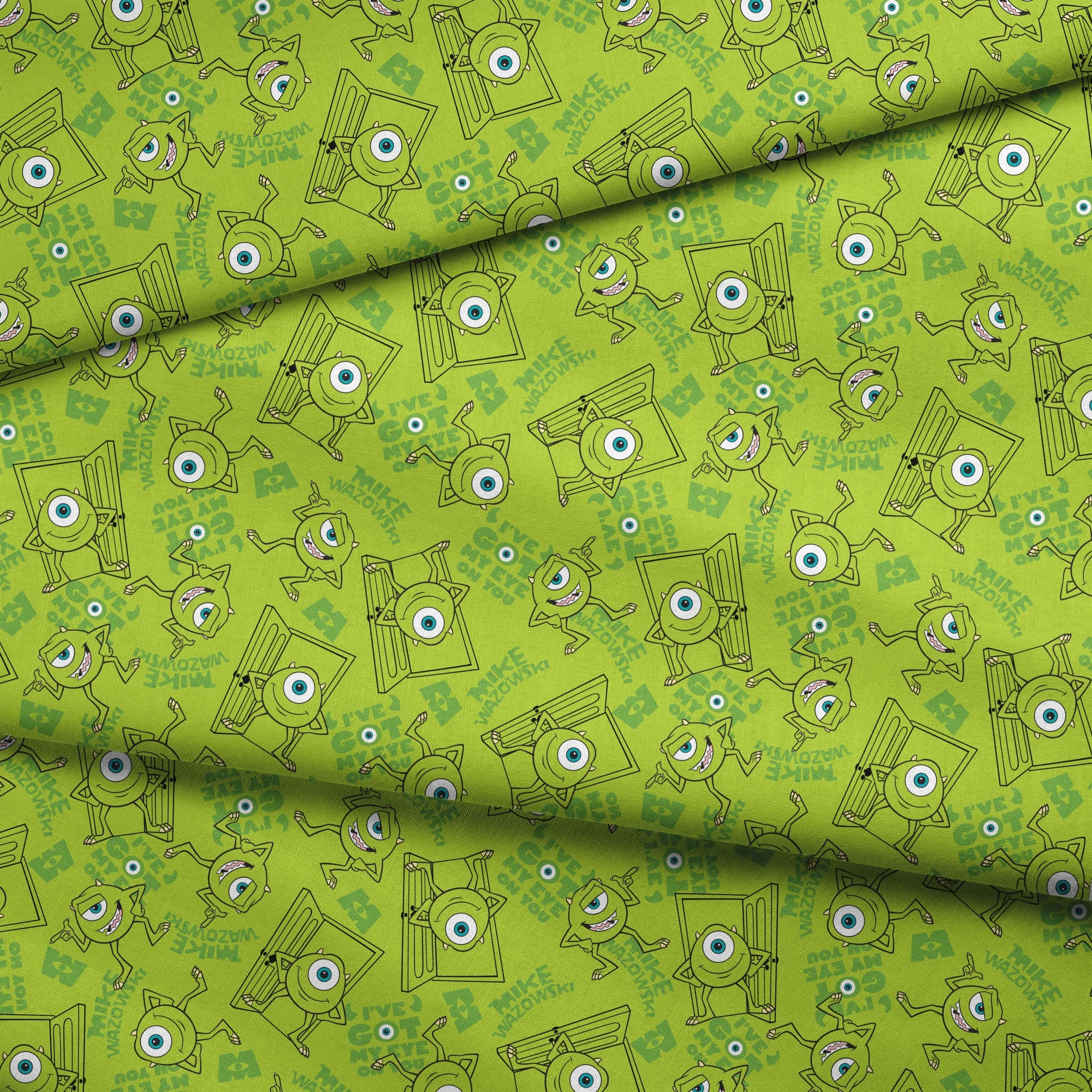 Green background with repeating Mike Wazowski in black outlines. fabric fold mockup