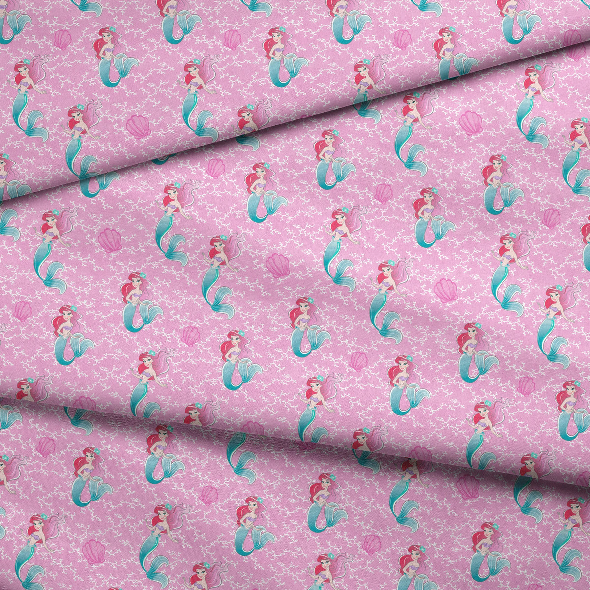 The Little Mermaid pattern with Ariel and purple seashells on pink background with white bubbles fabric fold mockup