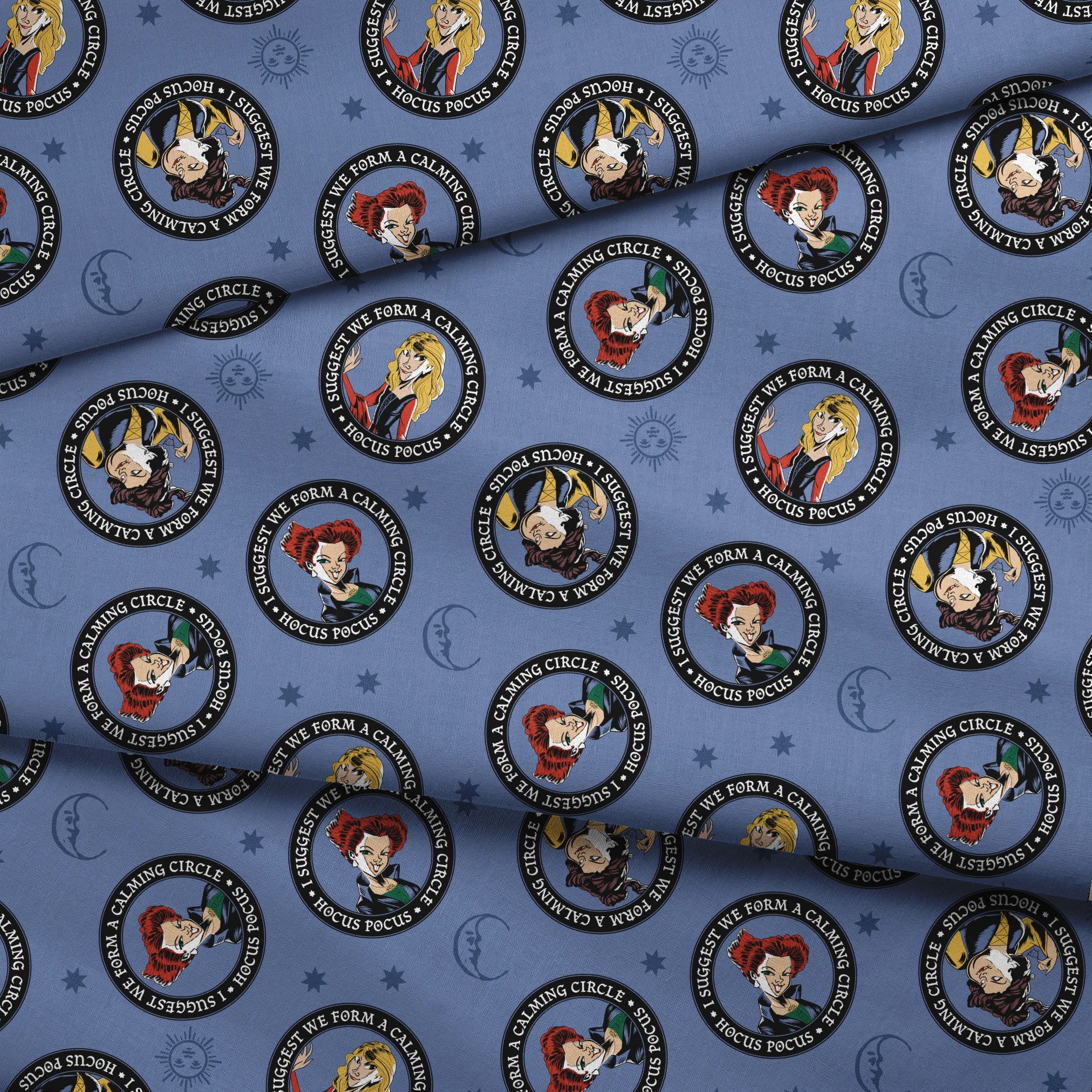 Cartoon witches in circular emblems with "Hocus Pocus" text on blue background with stars fabric fold mockup