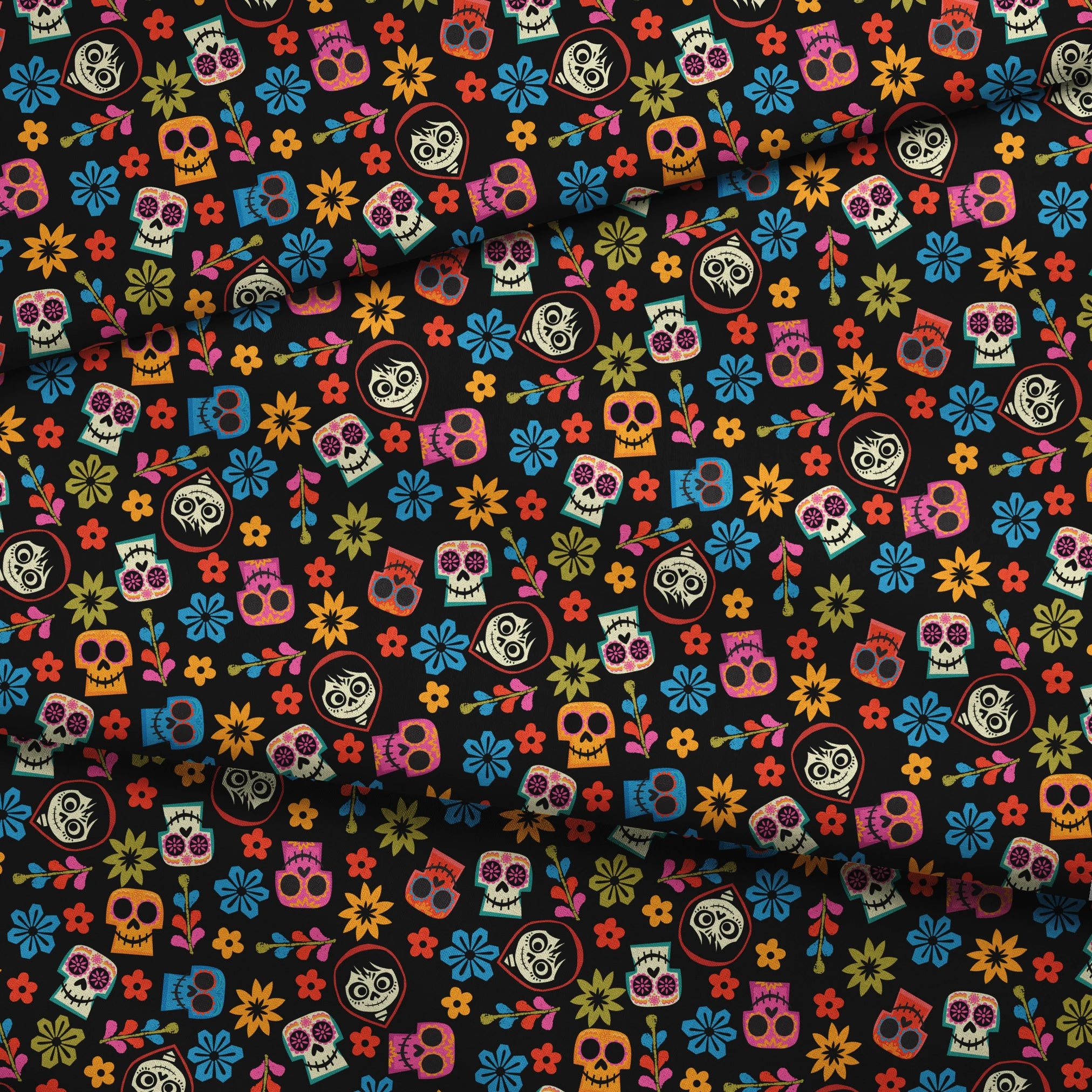 Colorful Coco sugar skull pattern with floral designs on black background for Day of the Dead fabric fold mockup